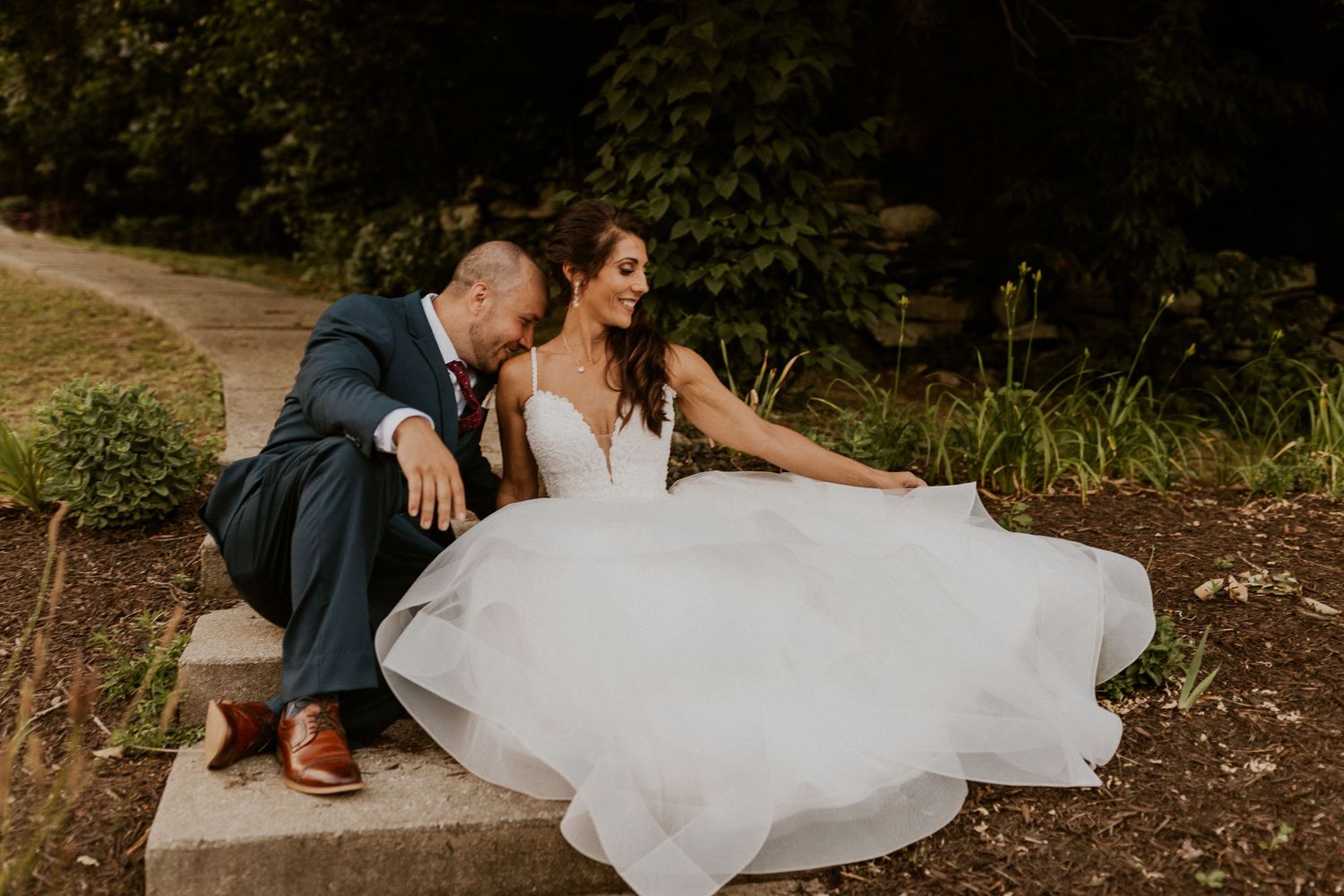 Wedding portraits captured in a natural outdoor setting with greenery.