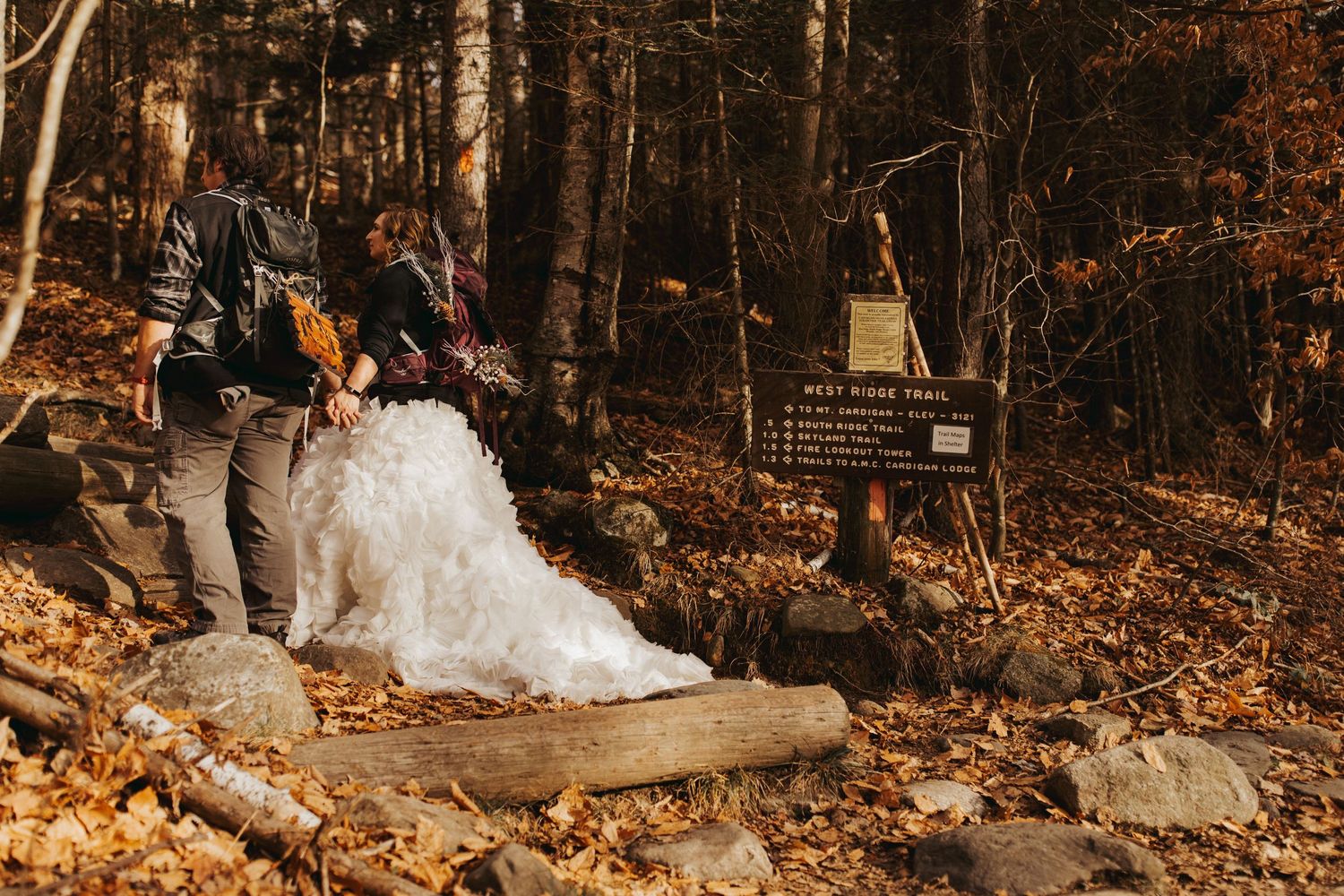 Jackie and Andy Brosonski hike the West Ridge Trail on Mount Cardigan in their wedding attire.