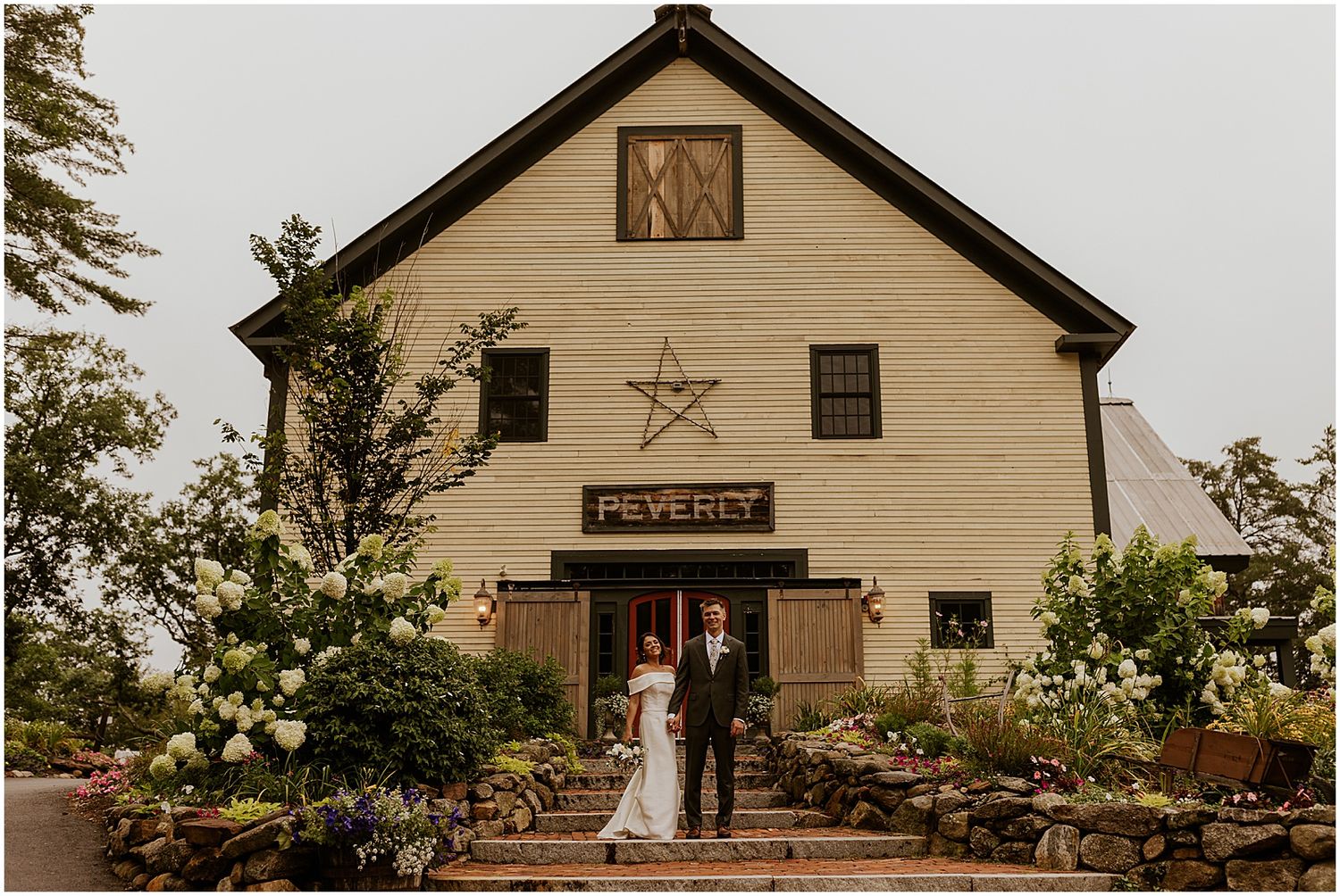 A rustic barn wedding venue with wooden exterior and decorative star detail.