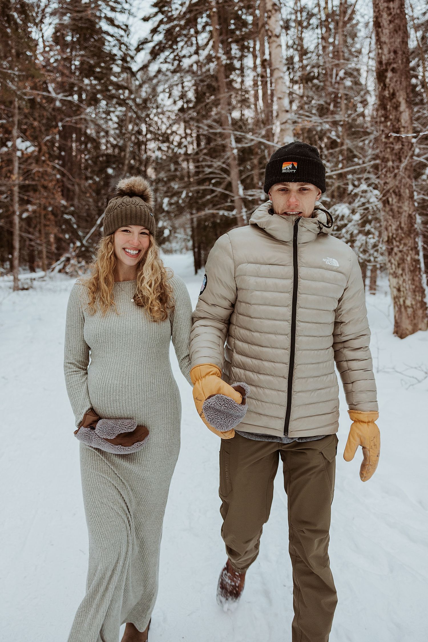 Couple taking maternity photos in the winter in NH