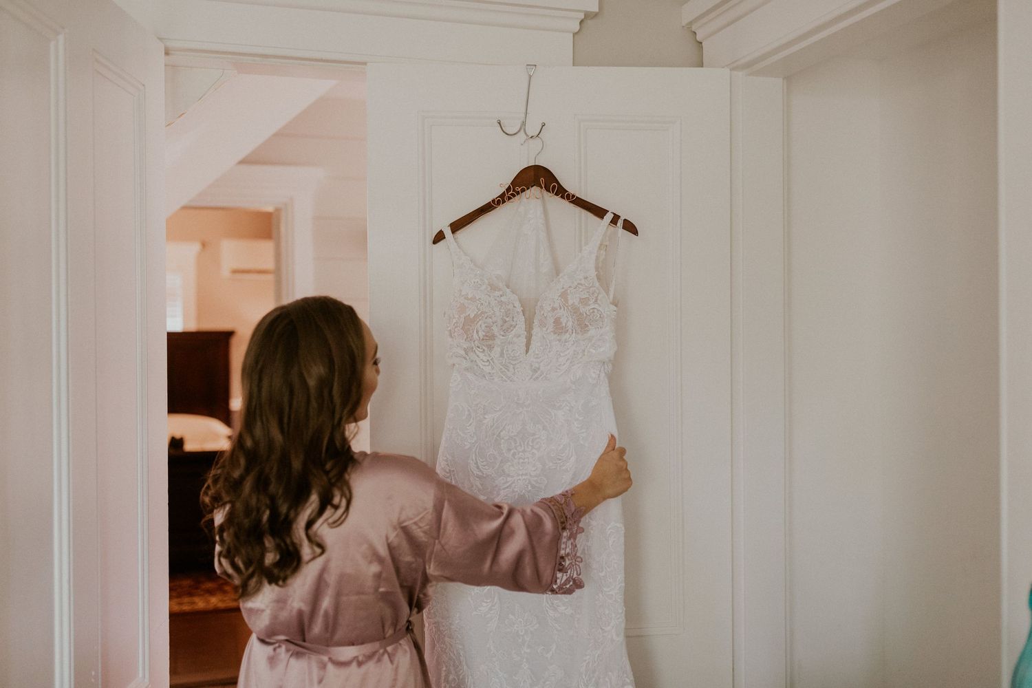 Chrissy admiring her wedding gown before it's time to put it on.
