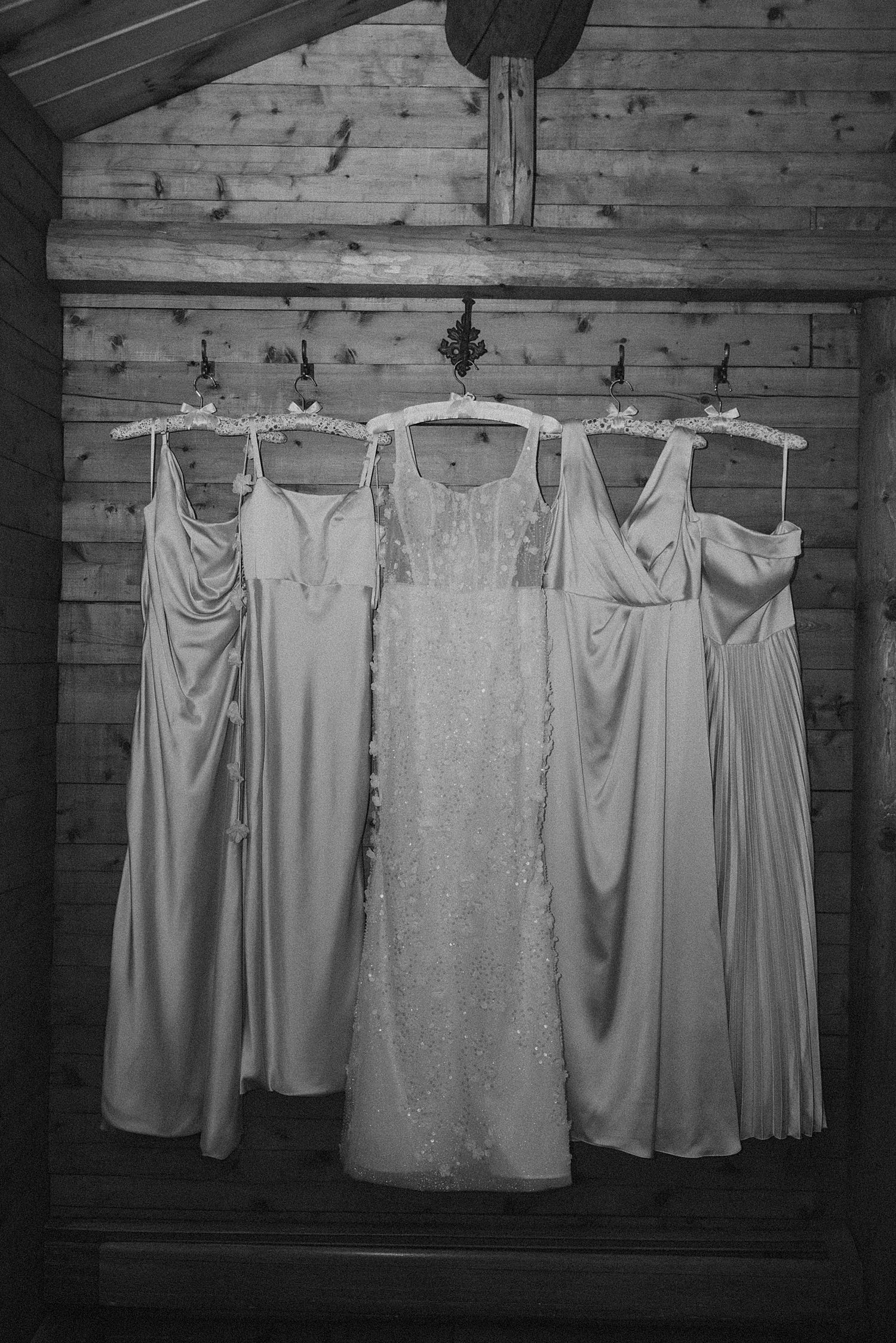 Wedding gown and bridesmaids dresses hanging up for a NH wedding at Longlook Farm