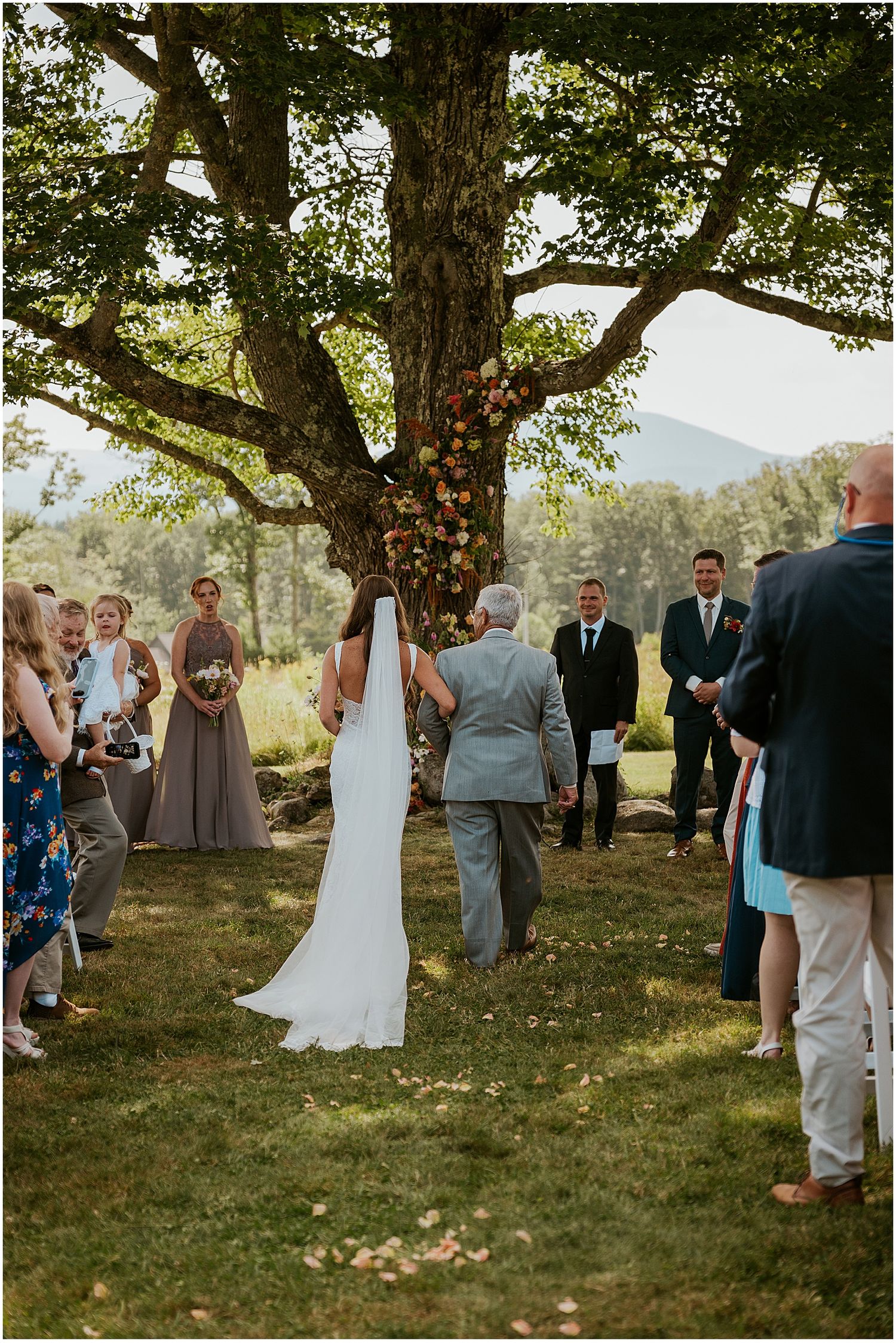 Bride walking down the aisle at her Whiteface Hollow wedding in NH