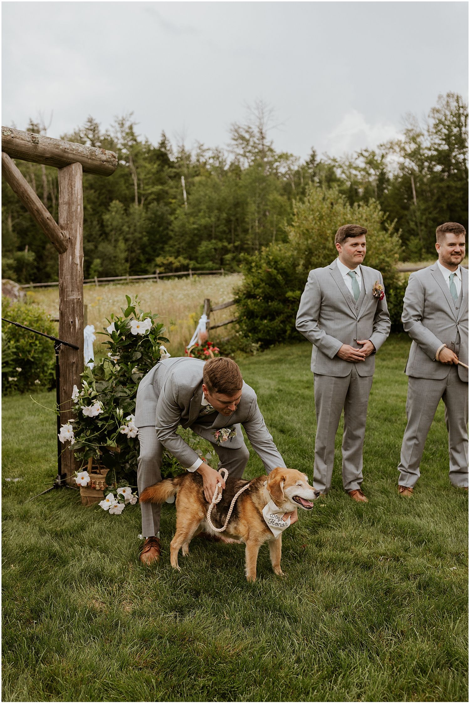 Groom waiting at the altar with his dog at the outdoor wedding venue in NH Locke Falls Farm