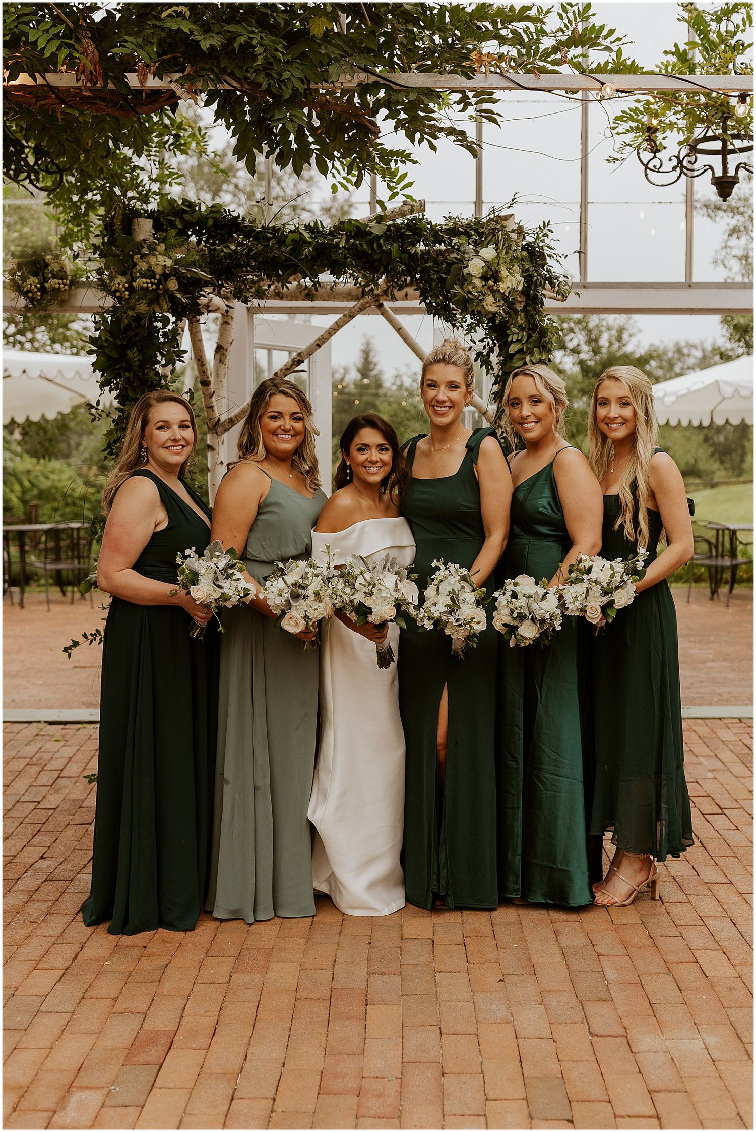 Green bridesmaid dresses with all white bouquet