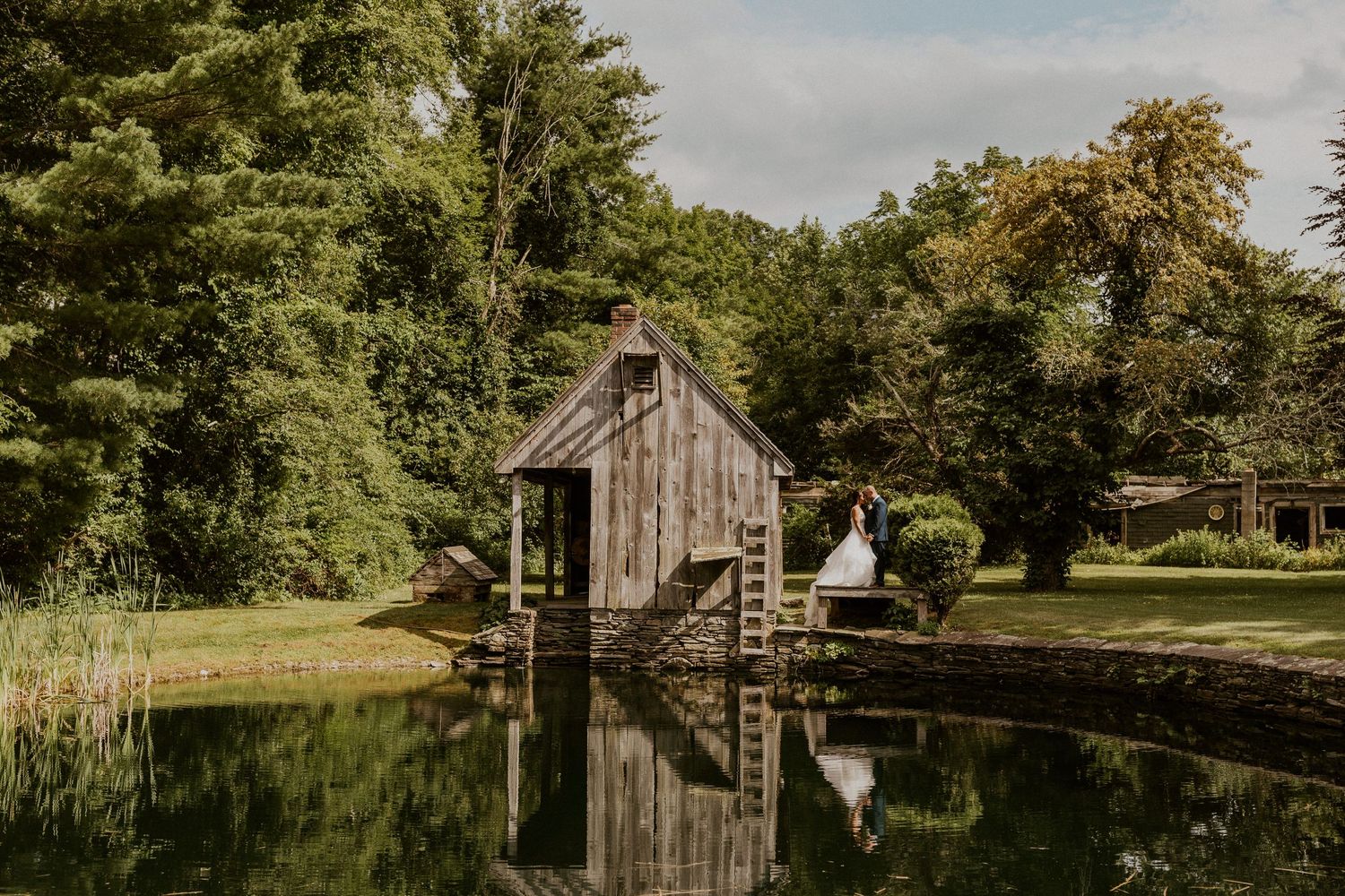 A bright and sunny portrait of Jessica and Mike by the pond at Wright's Mill Farm.