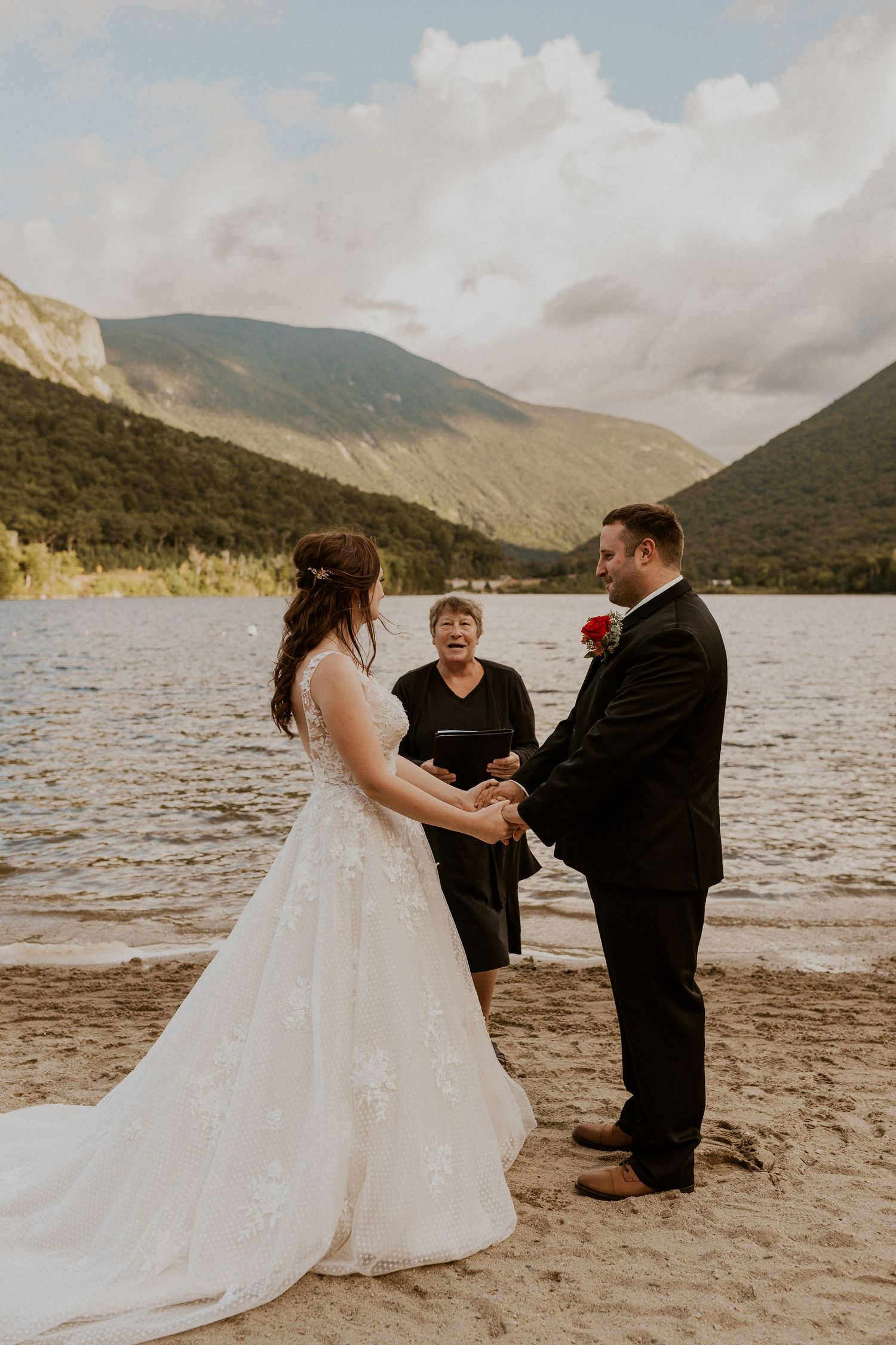 Bride and groom hold hands in front of the justice of the peace while declaring their love to each other.