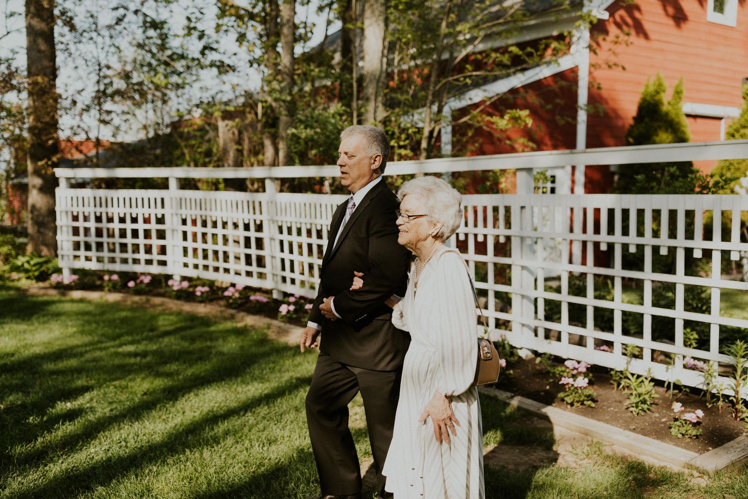 Wedding ceremony beginning, grandmother of the bride being walked in.