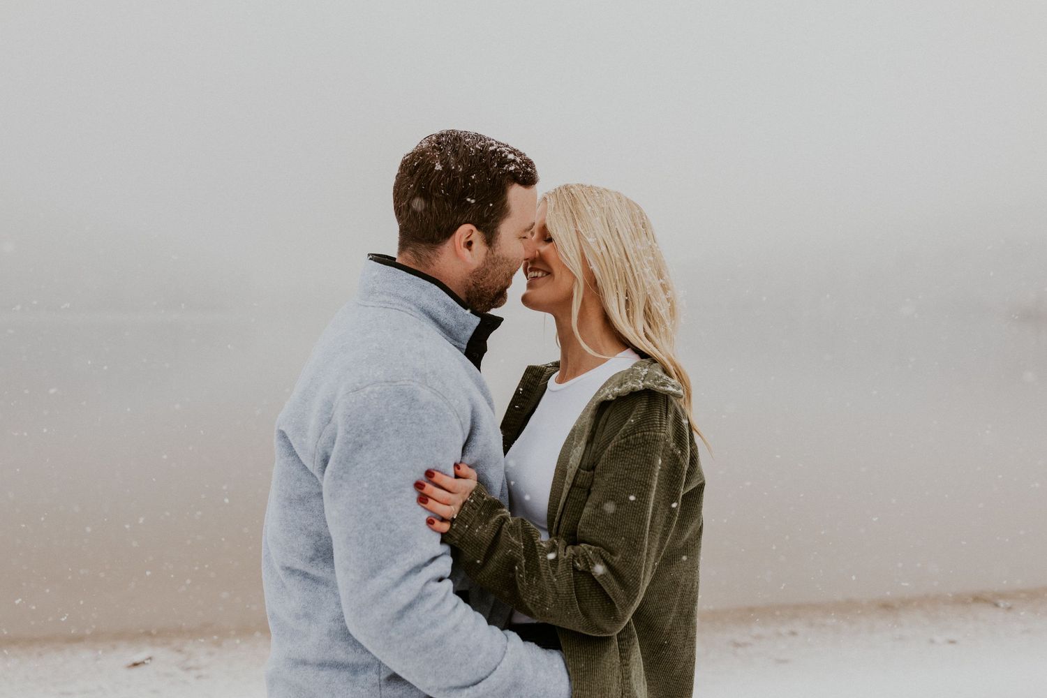 Newly engaged couple playfully posing for photos during their engagement session in Franconia New Hampshire.