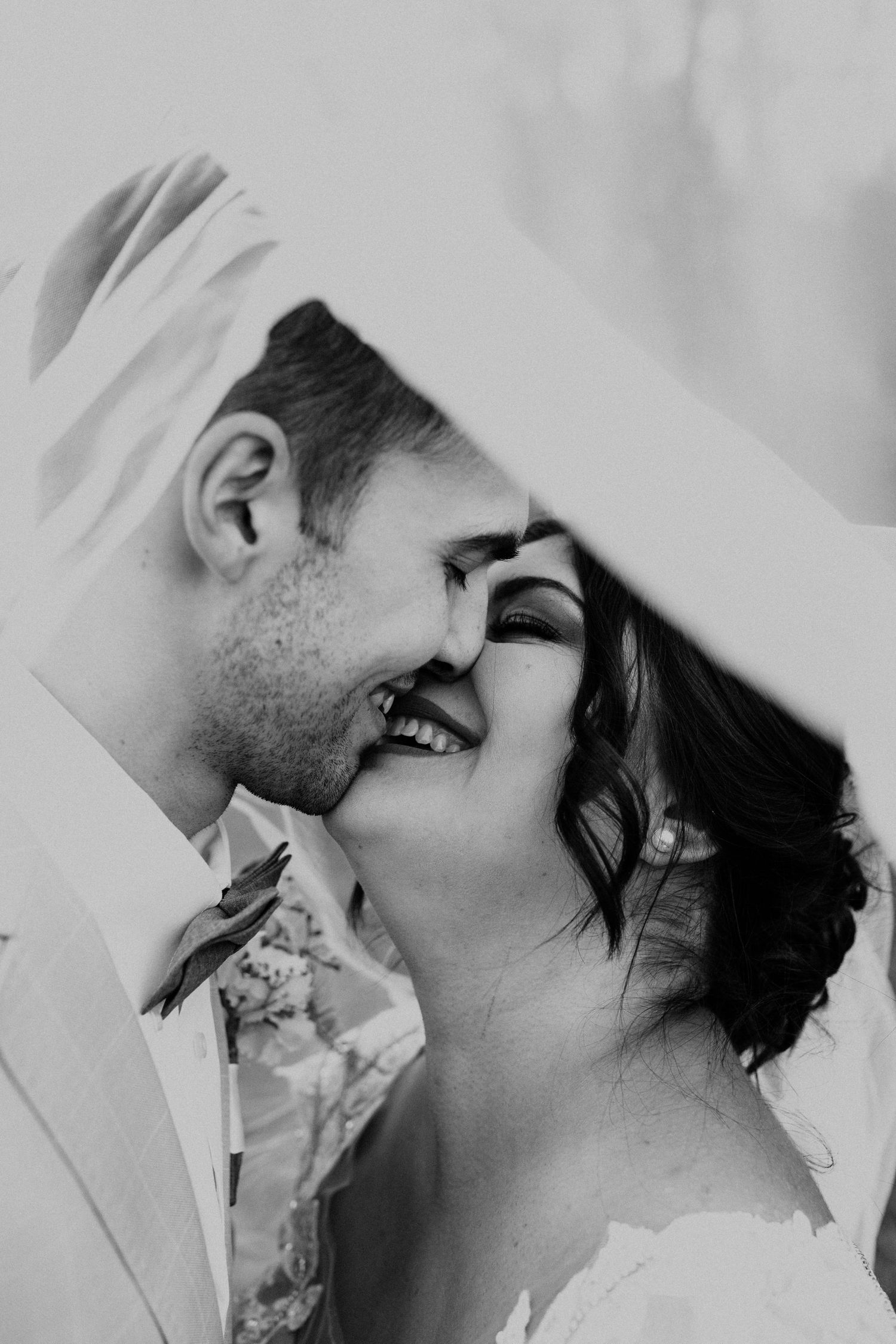 A romantic black and white close-up of a tender moment between two people.