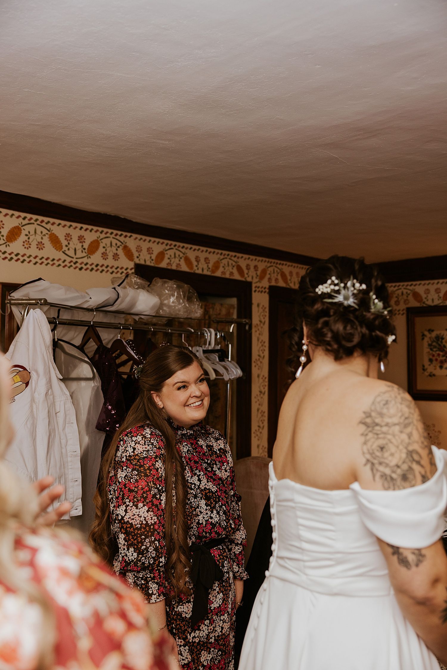 Bride getting into her wedding dress at the Barn at Powder Majors Farm in NH