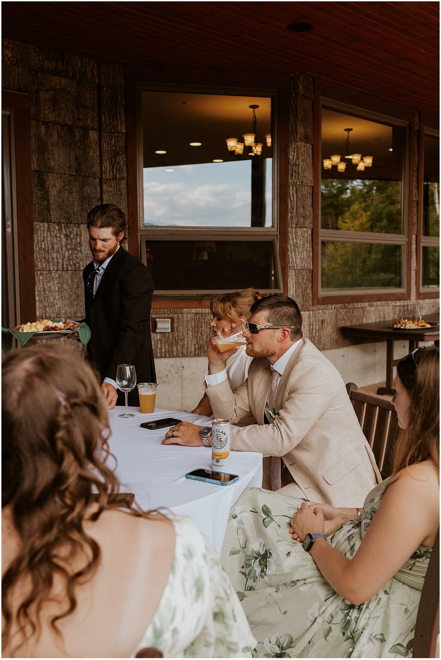 Groom and guests enjoying cocktail hour at a Maine wedding at a VRBO