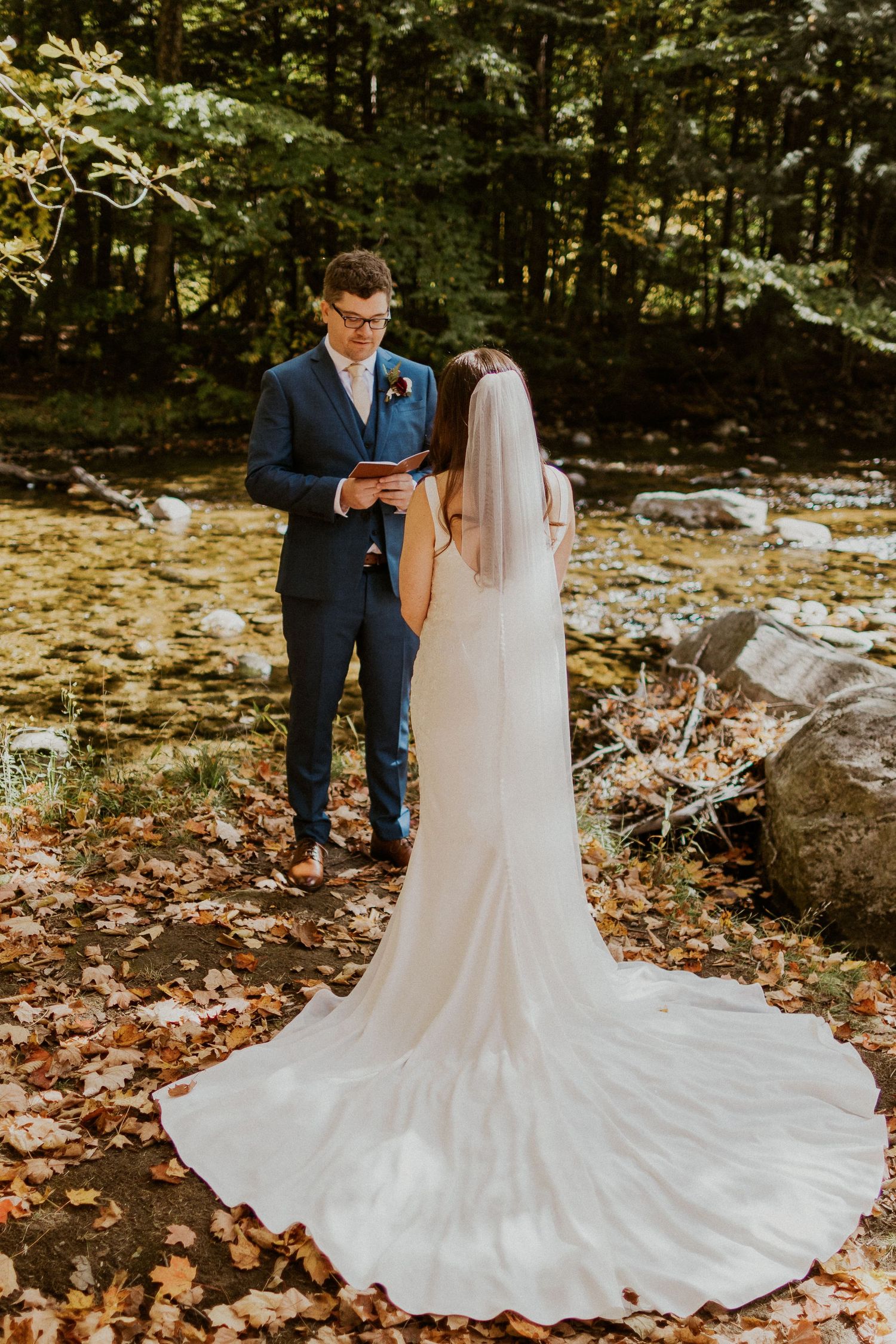 Daniel reading his private vows to Briana along the Pemi River in Woodstock New Hampshire.