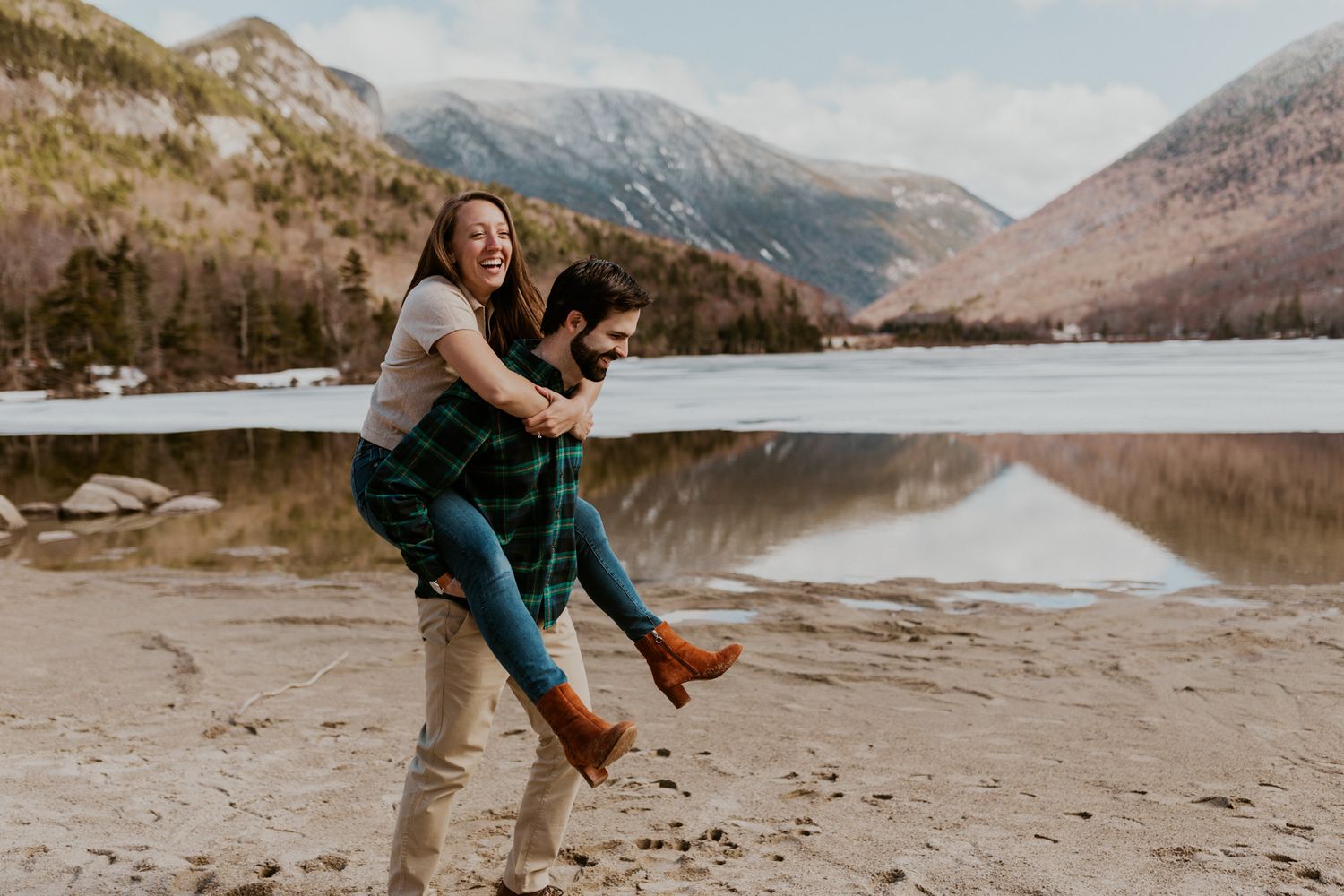 A happy couple playing in front of Echo Lake in Franconia Notch State Park