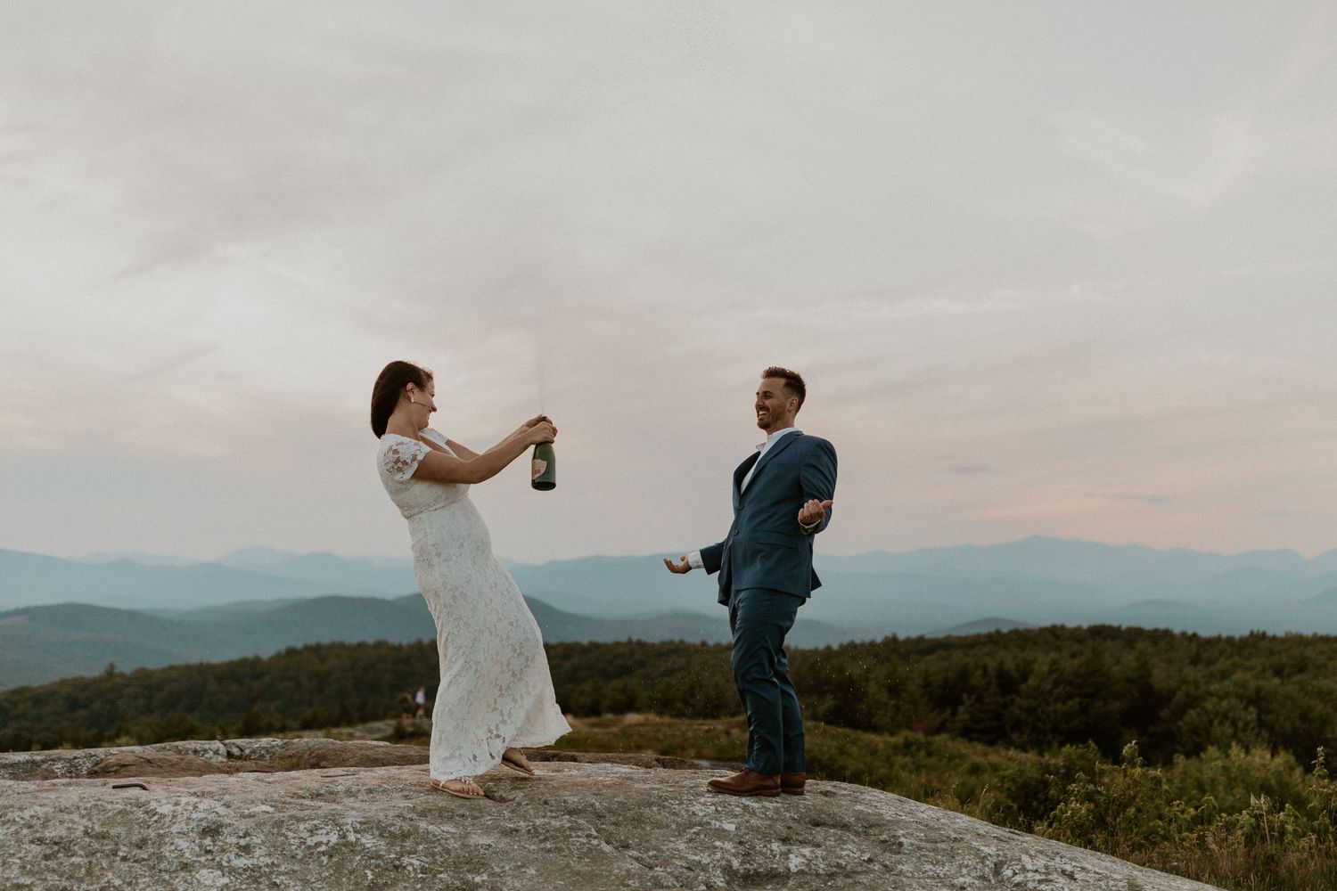 Danielle and Colin dressed in their wedding attire for their one year anniversary photoshoot on Foss Mountain in NH.