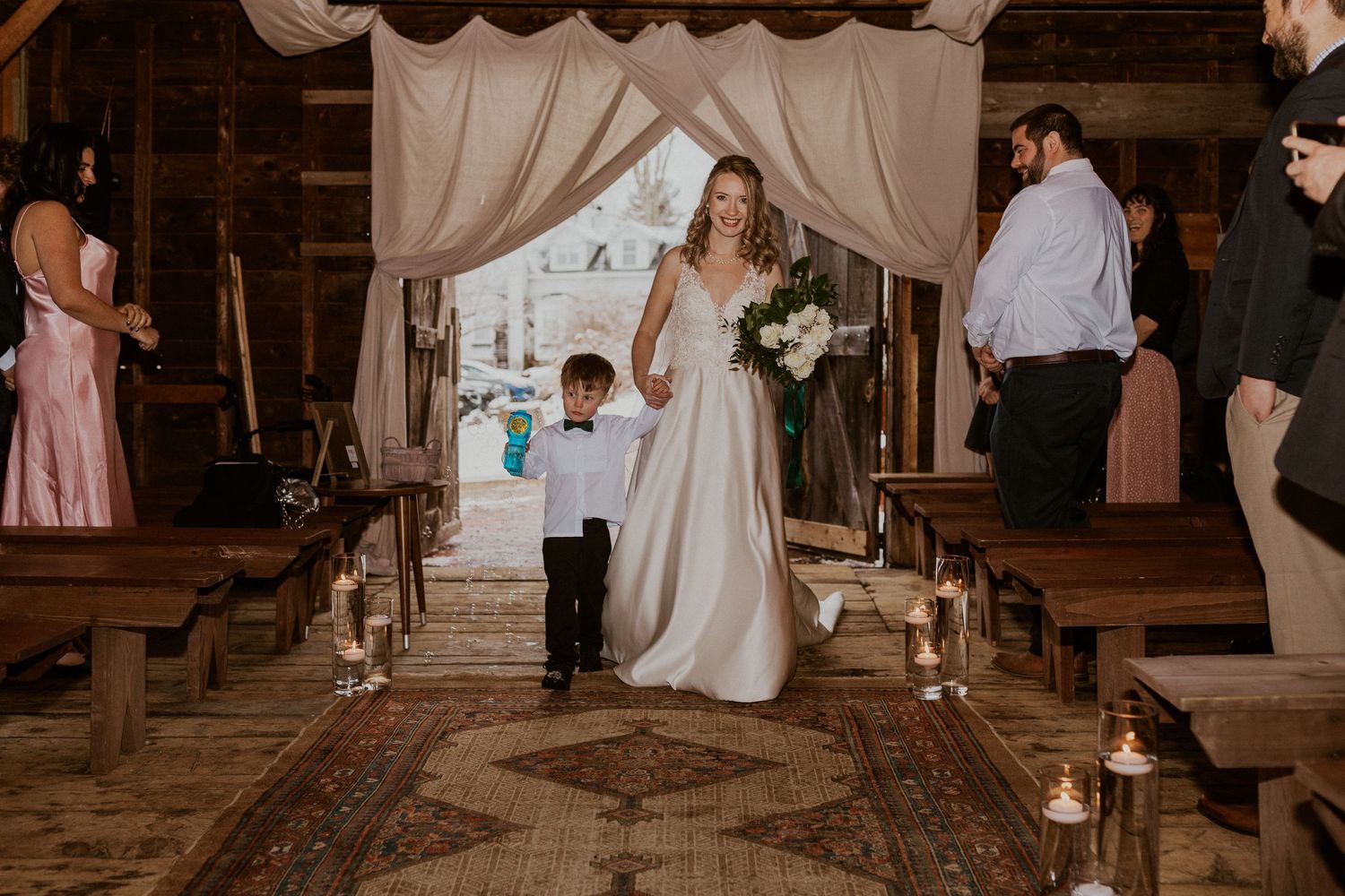 Deirdre and her nephew Colby walking down the aisle at the wedding ceremony in Tamworth New Hampshire.
