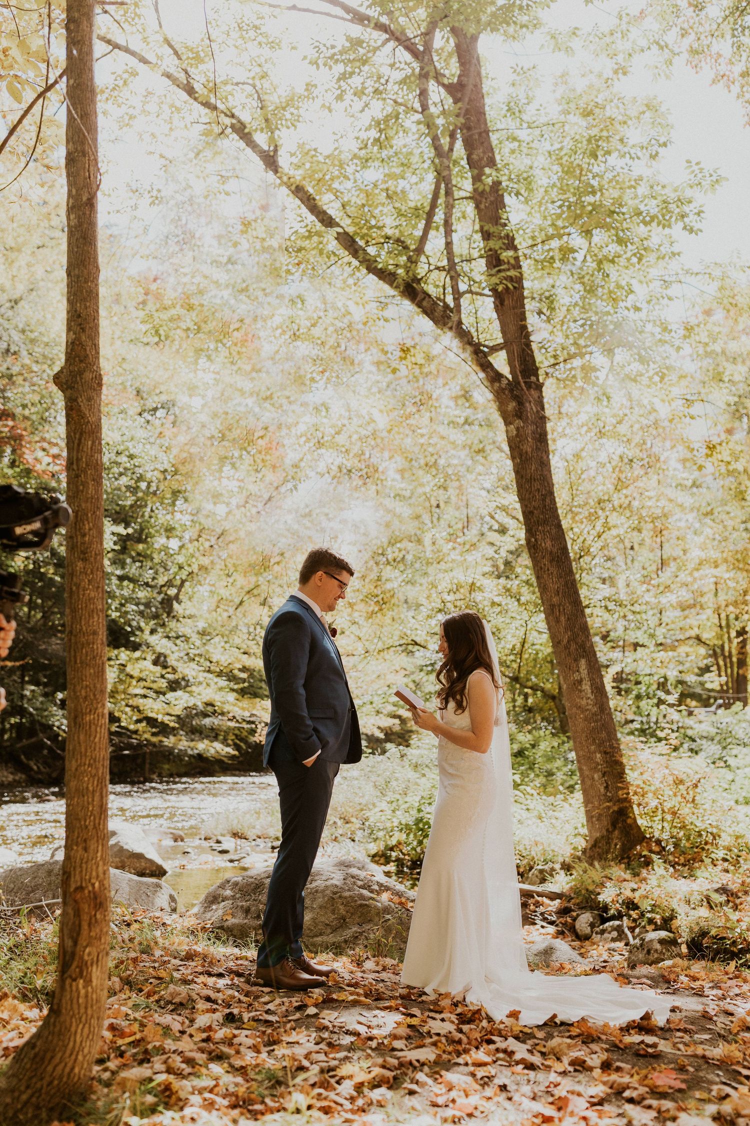 Briana reading her private vows to Daniel along the Pemi River in Woodstock New Hampshire.