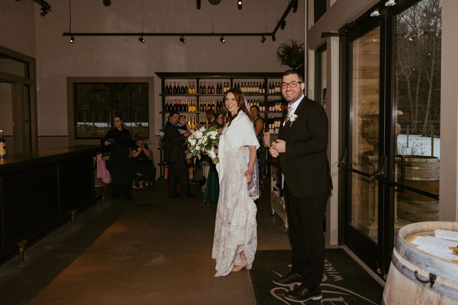 Panoramic view of a dimly lit indoor wedding reception venue with elegant decor.
