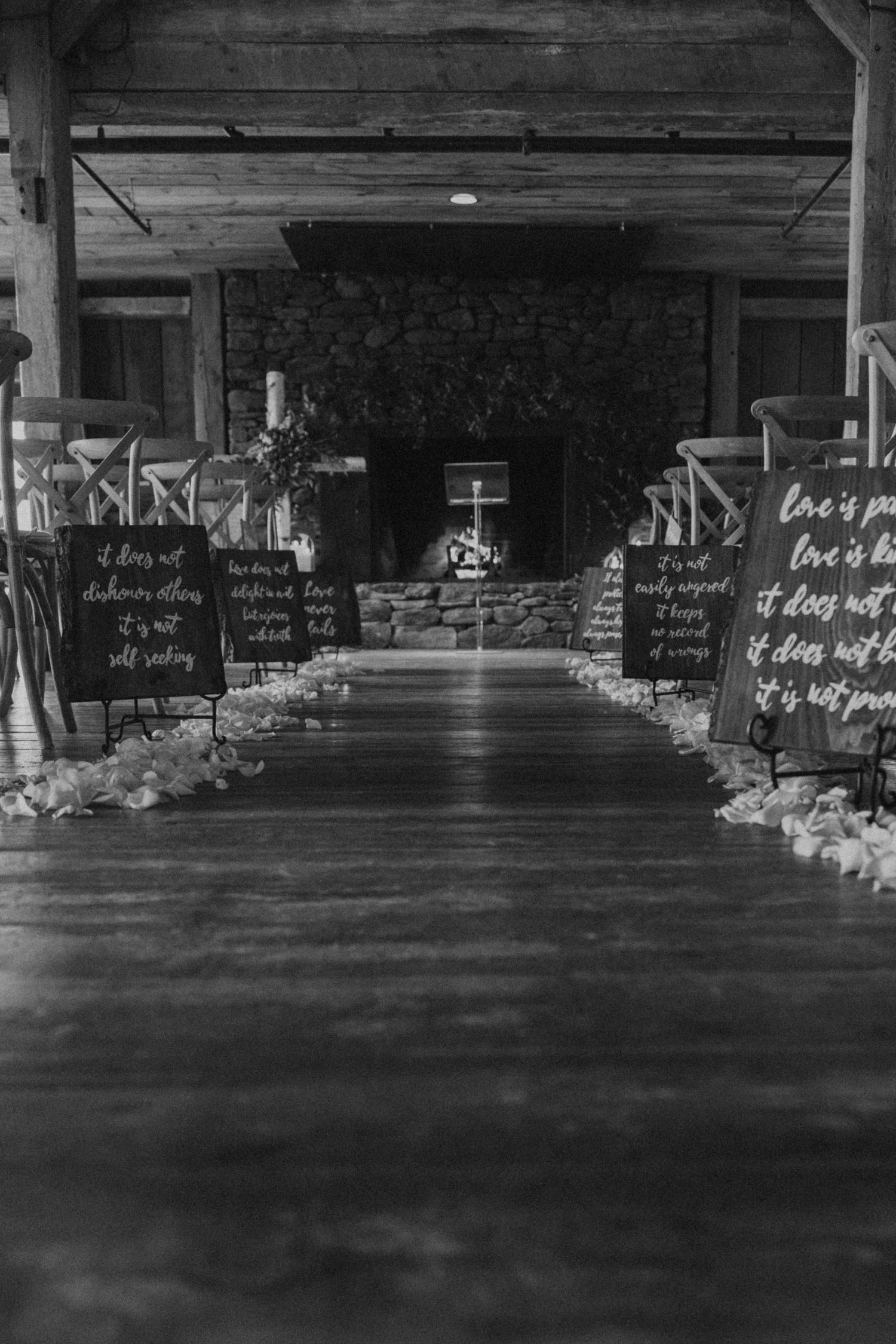 Dark moody wedding venue interior with rustic chalkboard signs and ambient lighting.