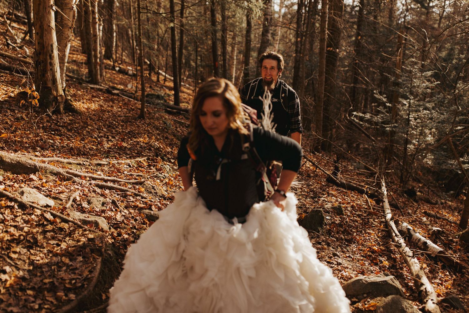 Jackie and Andy Brosonski hike the West Ridge Trail on Mount Cardigan in their wedding attire.