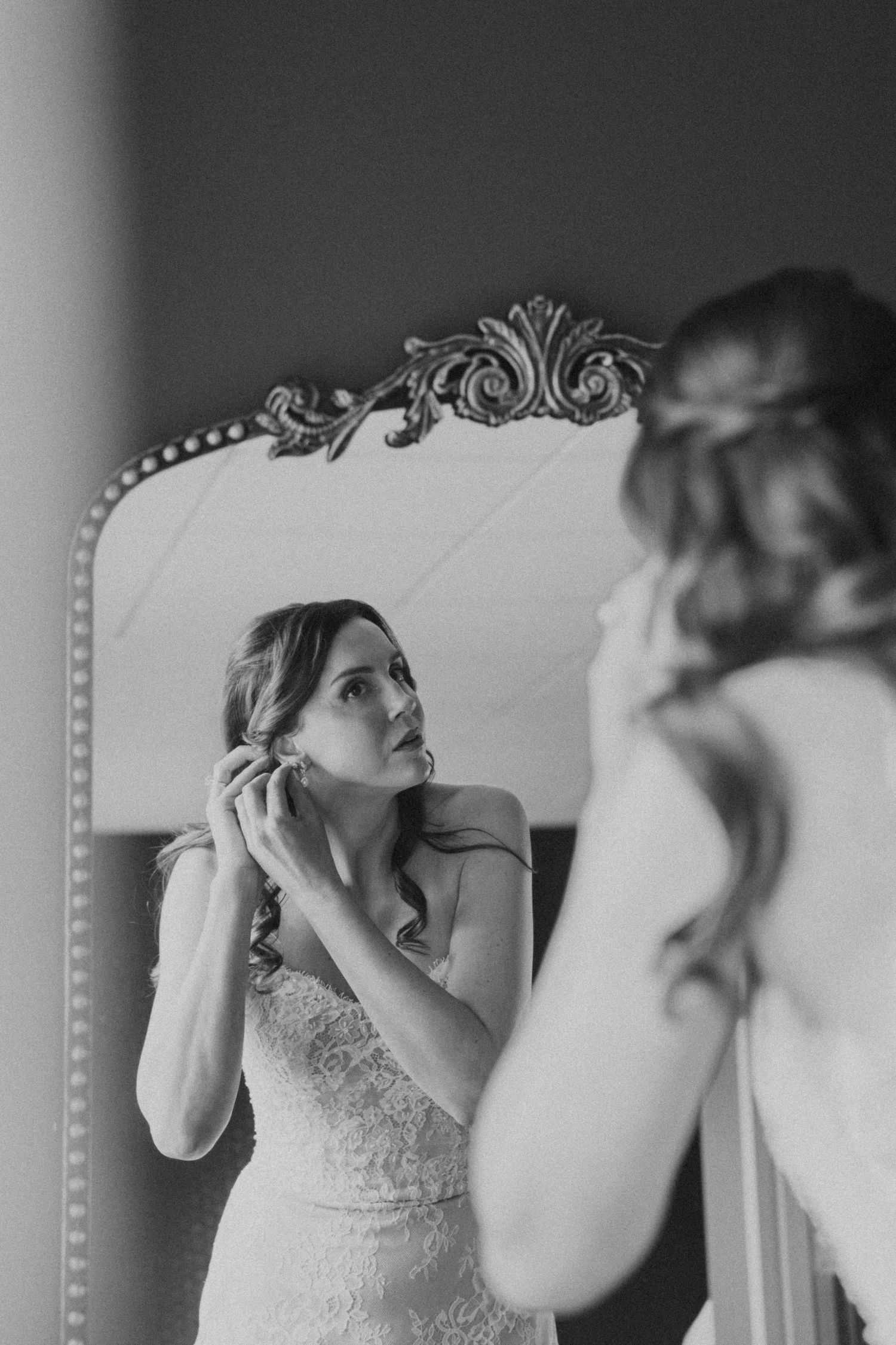 A sequence of black and white photos showing a bride putting on earrings while getting ready for her wedding day.
