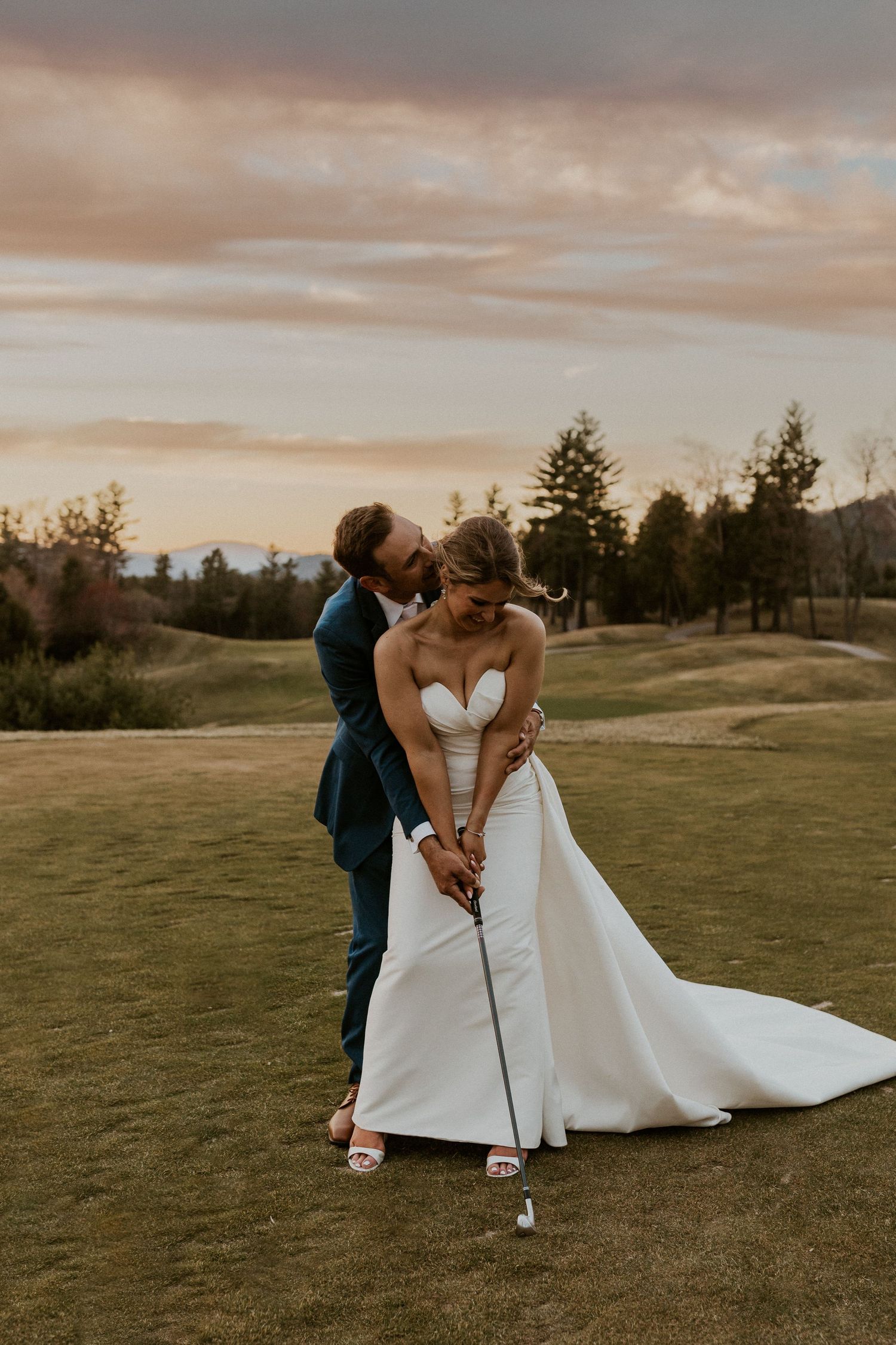 Kendra and Andrew golfing together at sunset after their Owl's Nest Resort Wedding.