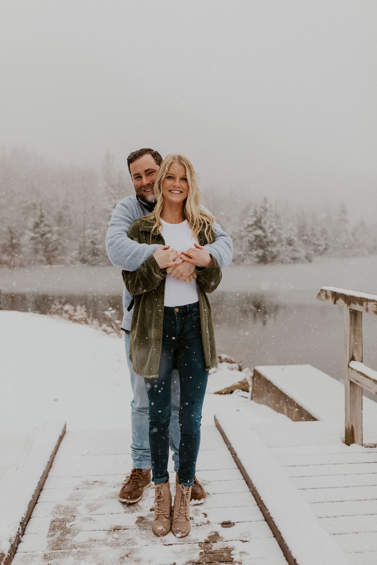 Newly engaged couple playfully posing for photos during their engagement session in Franconia New Hampshire.