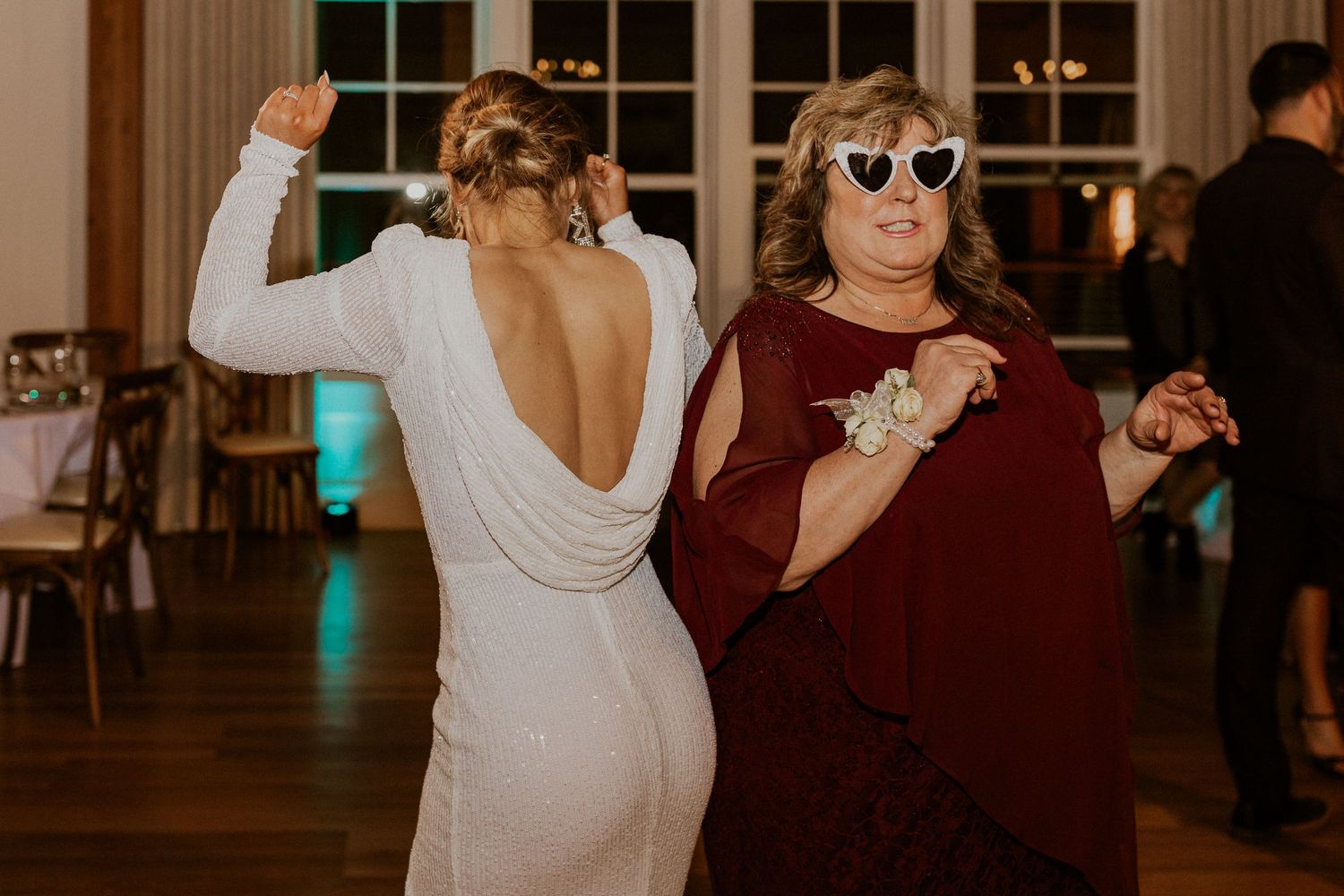 The bride and her mother dancing together