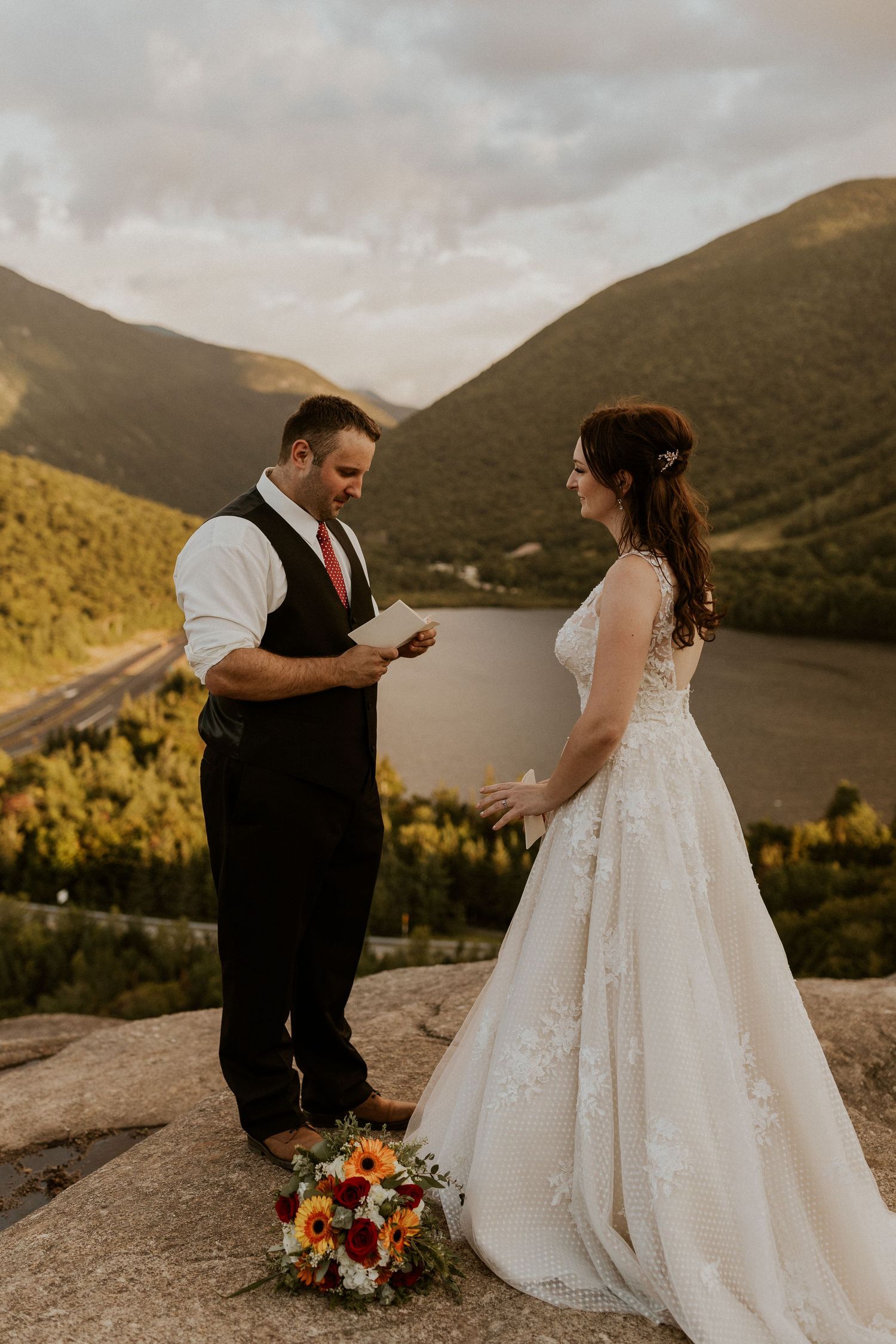 The groom sharing his private vows with the bride on top of Artist Bluff in Franconia New Hampshire.