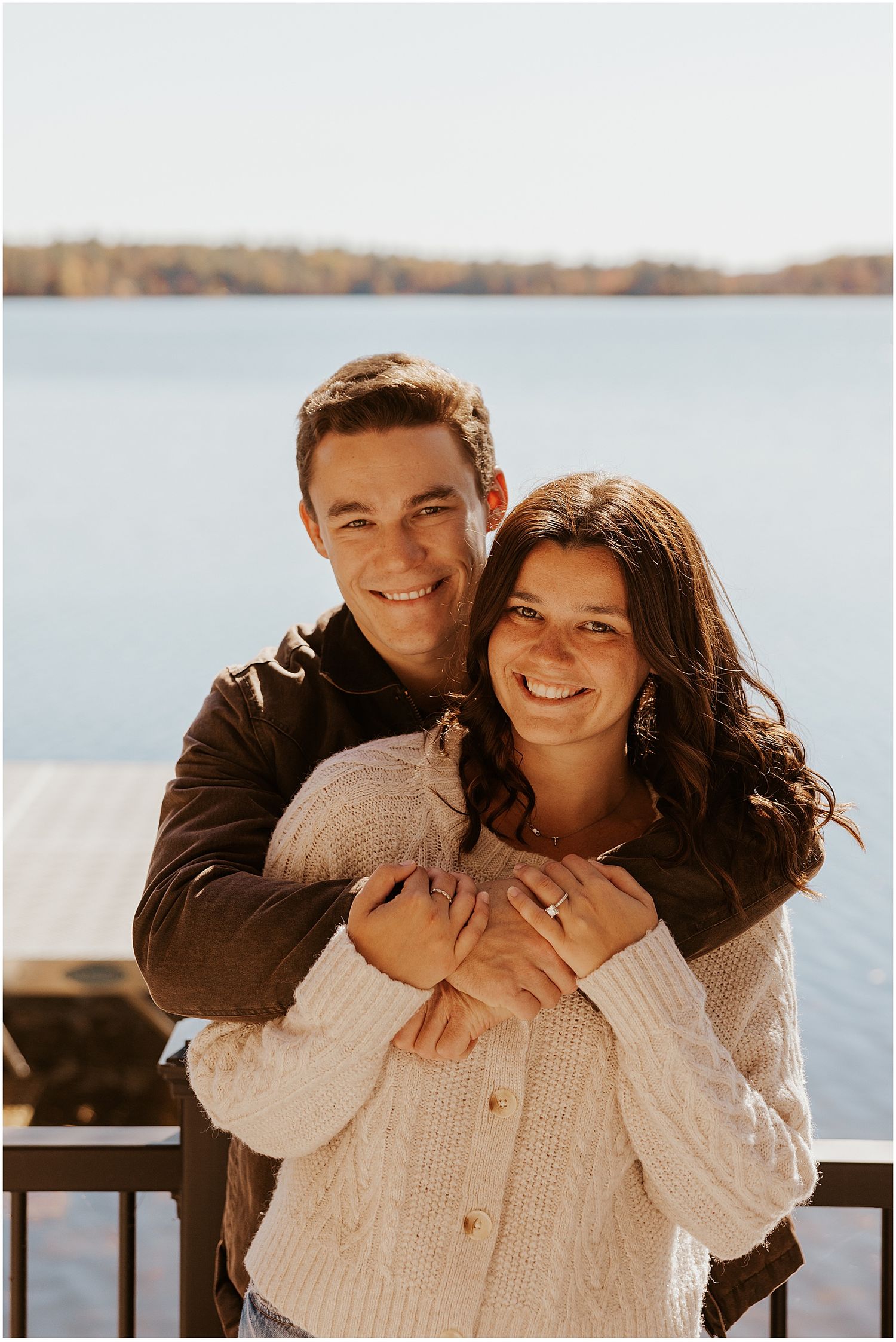 New Hampshire couple taking engagement photos at a lakehouse