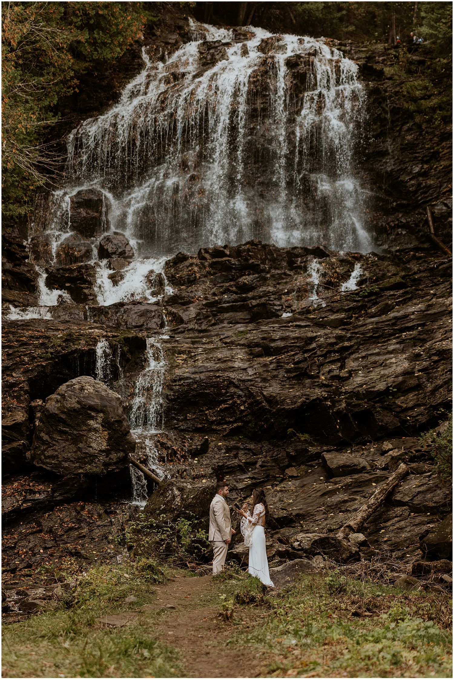 Bride and groom having a first look by a NH waterfall - unique wedding ideas