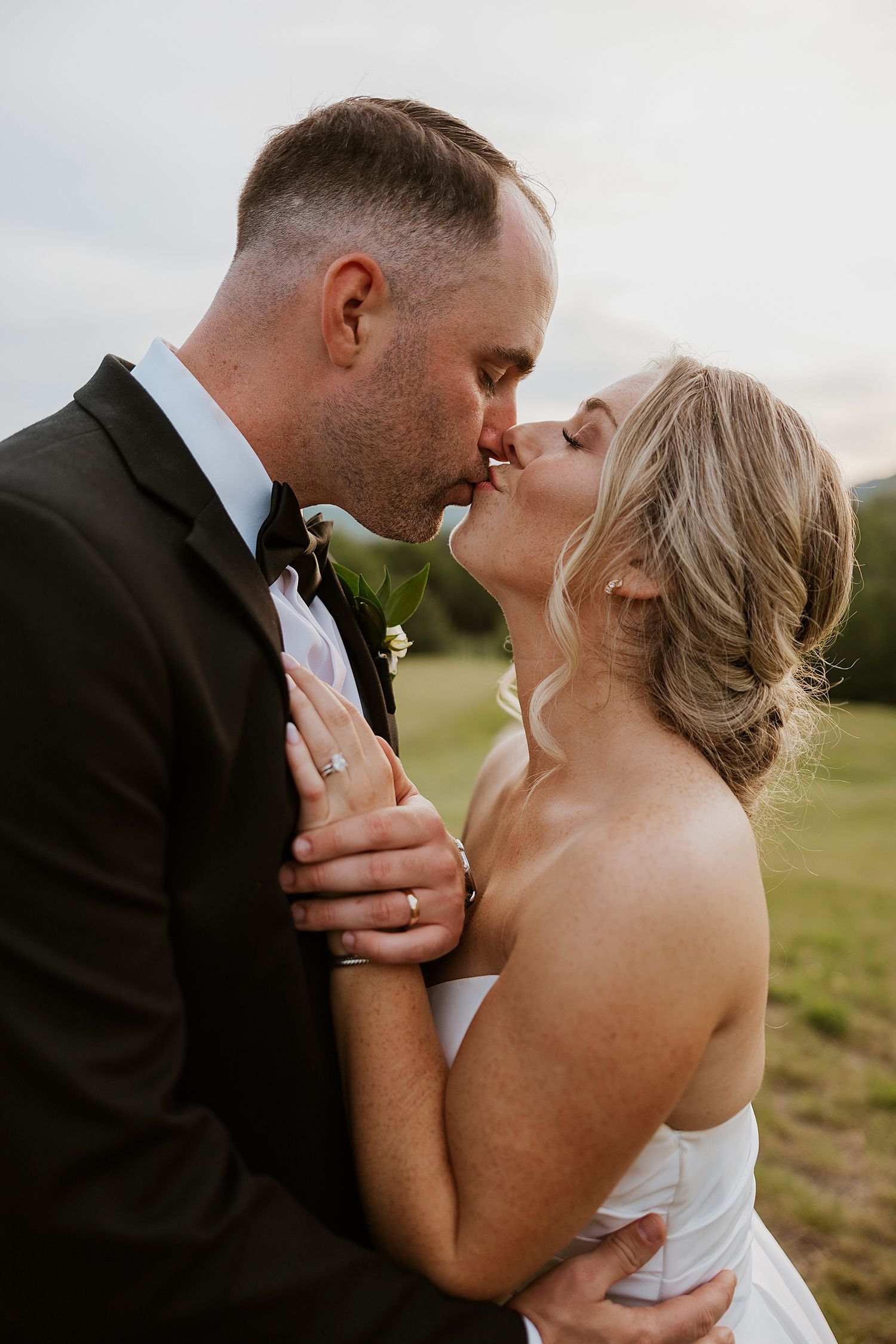 Bride and groom kissing outside their Owl's Nest Resort wedding in New Hampshire