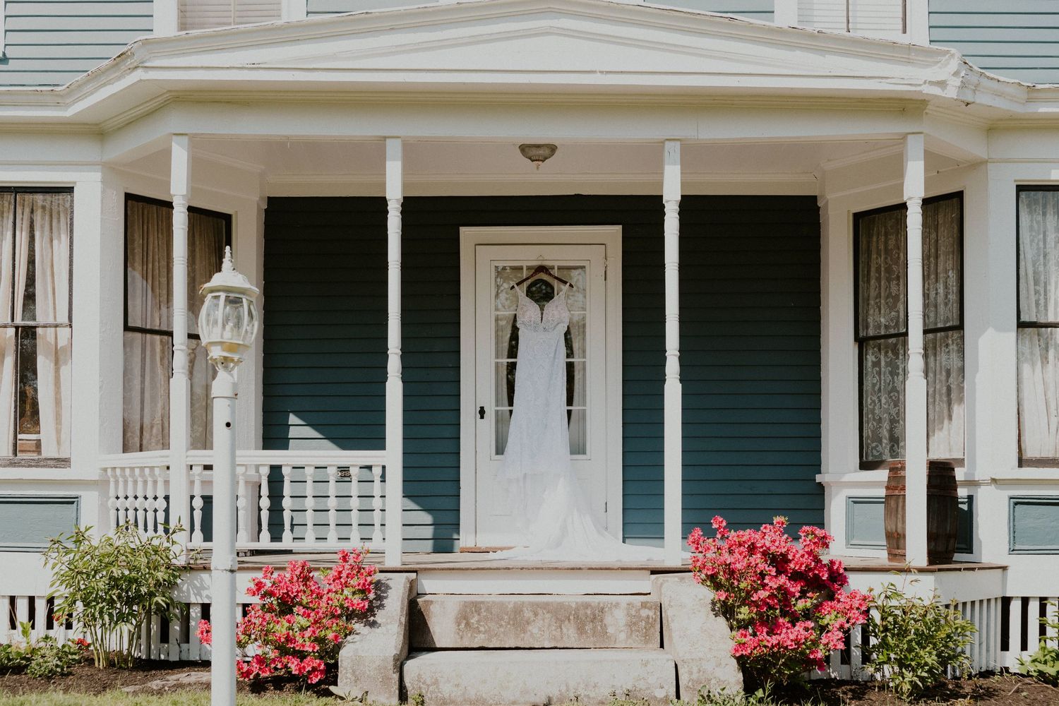 Essence of Australia Wedding Gown hanging on the front porch of the Arabella Estate in Buxton Maine
