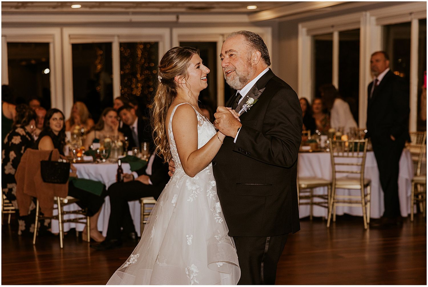 Couples dancing together at an elegant wedding reception with warm lighting.