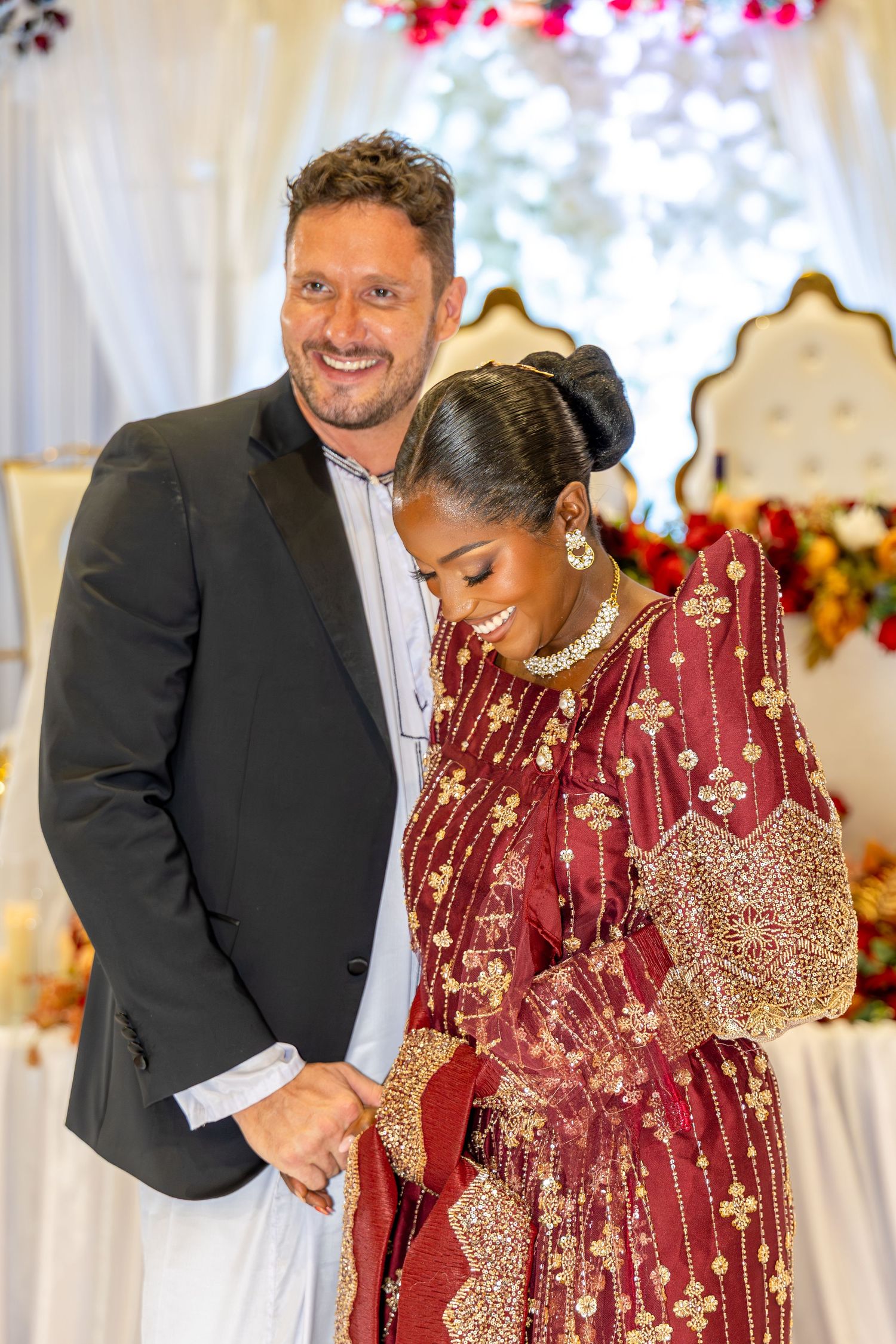 Joyful celebration moment captured at an elegant indoor event with floral decorations.