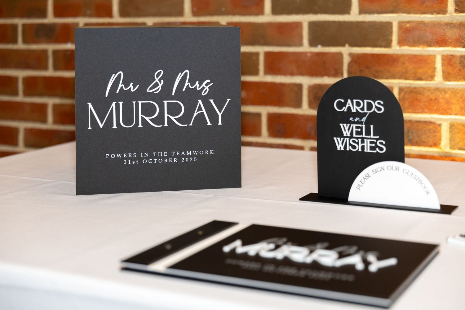 Mr and Mrs Murray wedding guest book and cards table display at a wedding reception.