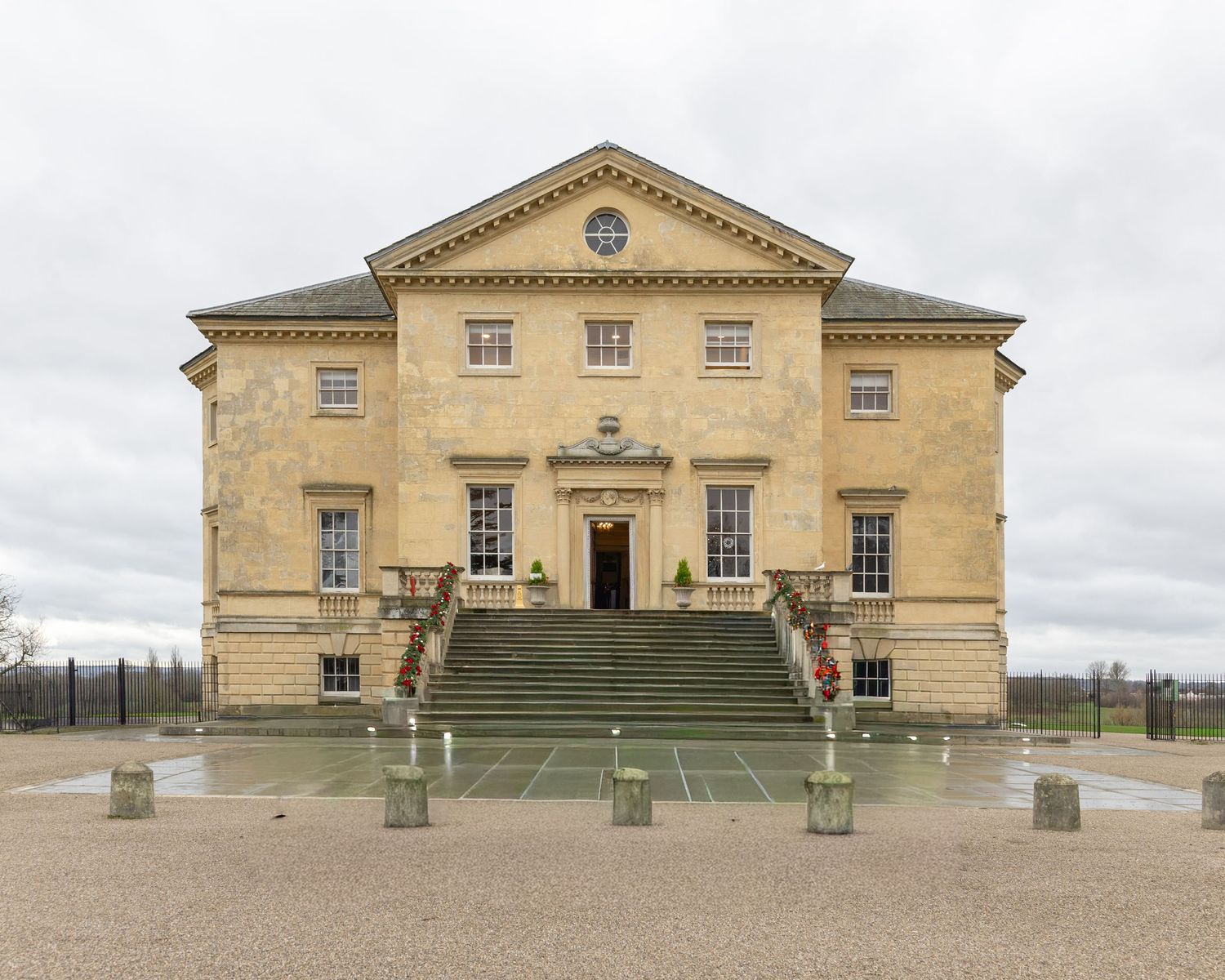 Front view of a grand Georgian manor house with symmetrical steps and classical architecture.