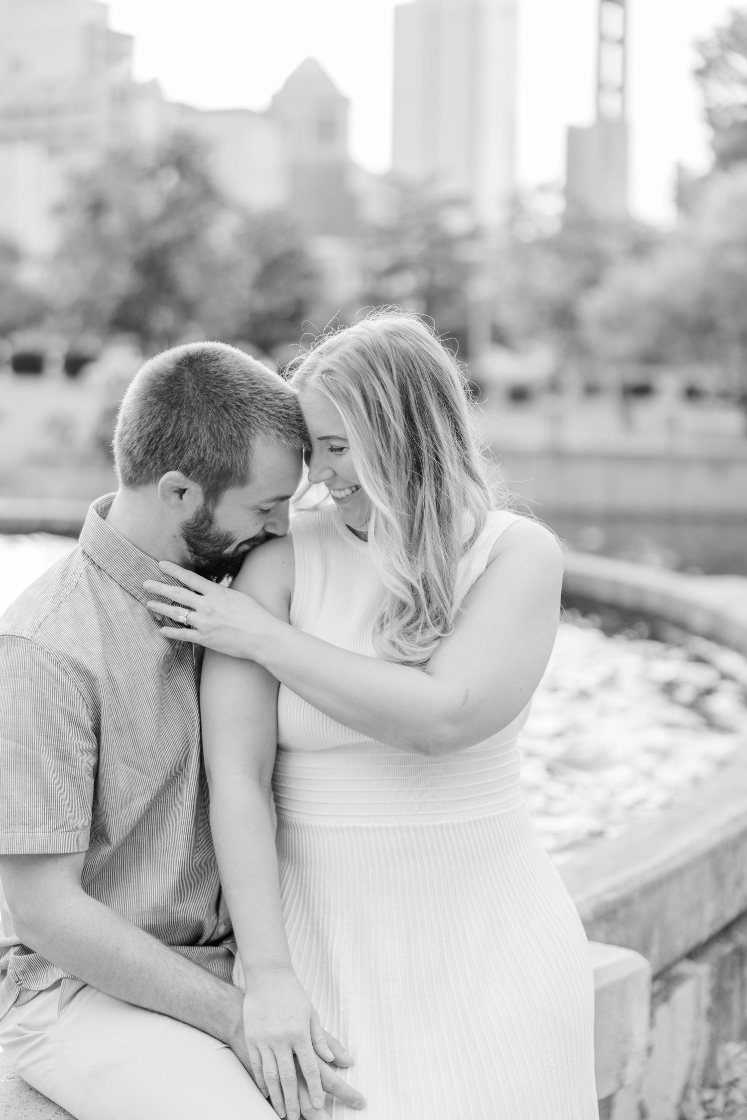 A romantic black and white photo series showing a couple embracing outdoors.