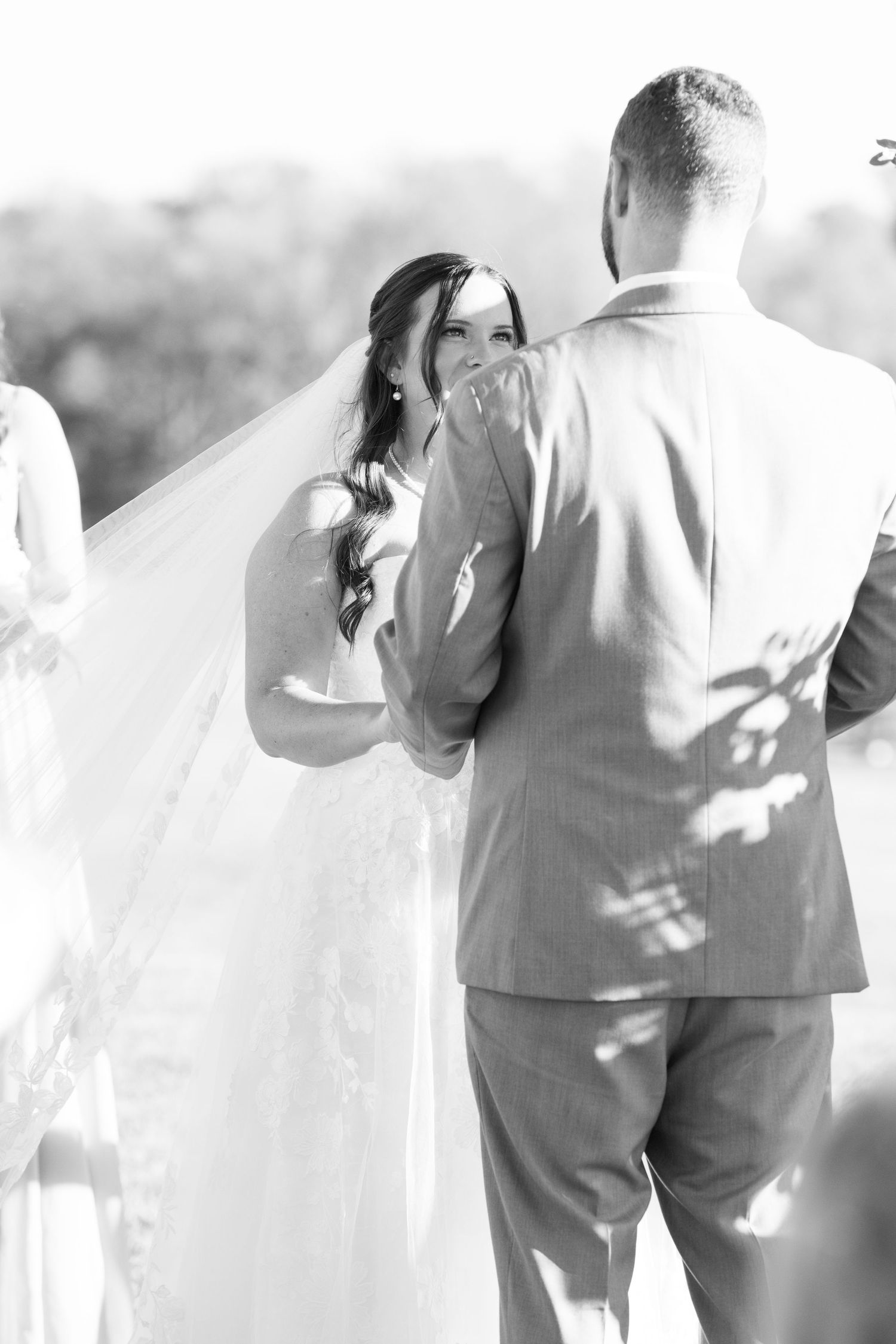Black and white photo of tender moments between the wedding couple in soft natural light.