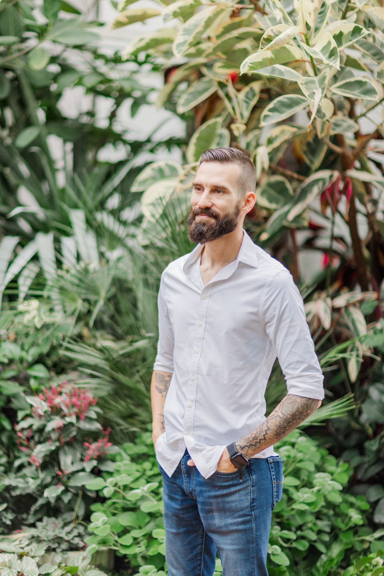 A casual outdoor portrait series showing a white shirt and jeans against a lush garden backdrop.