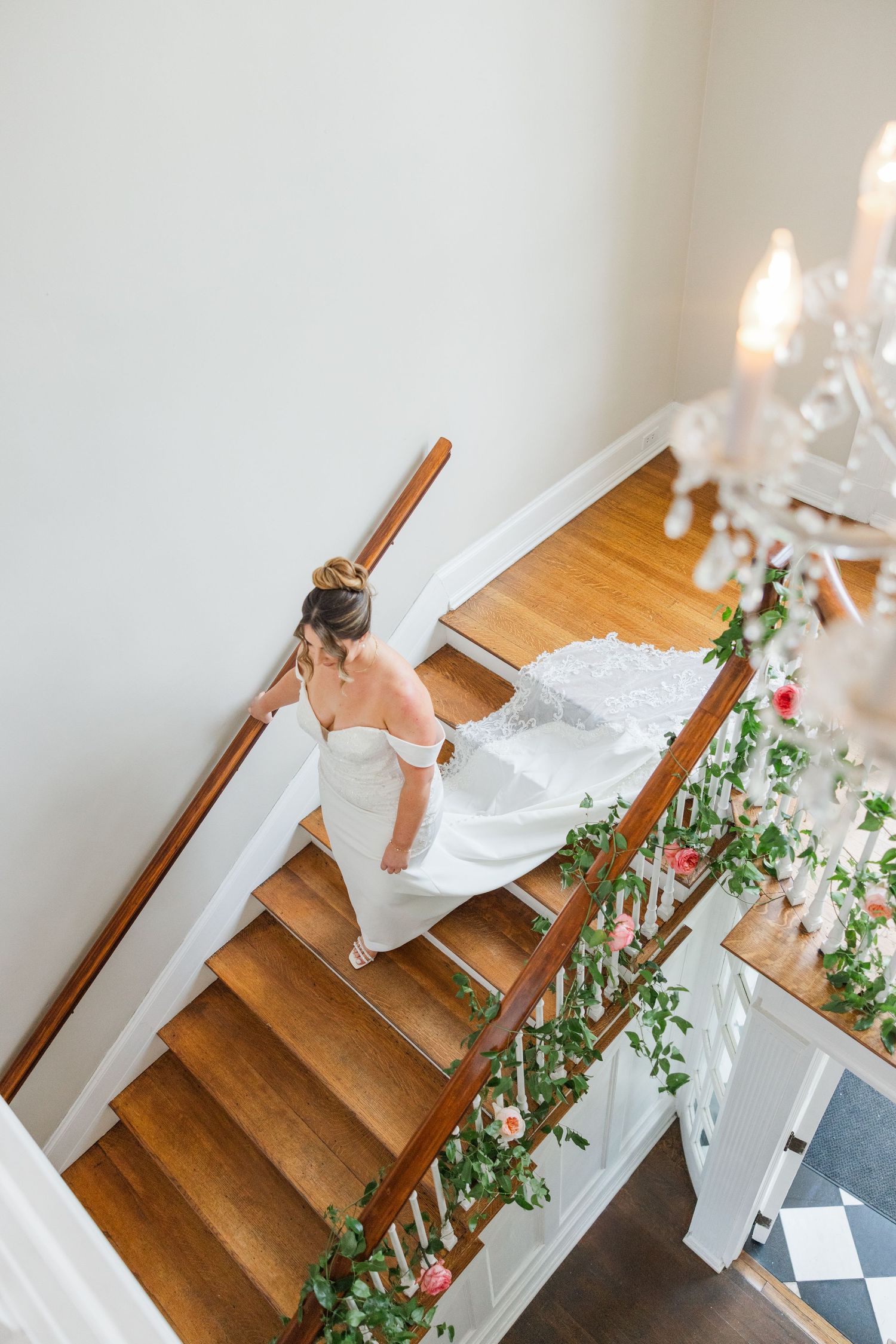 Wooden staircase decorated with romantic candlelight and floral garlands for a wedding.