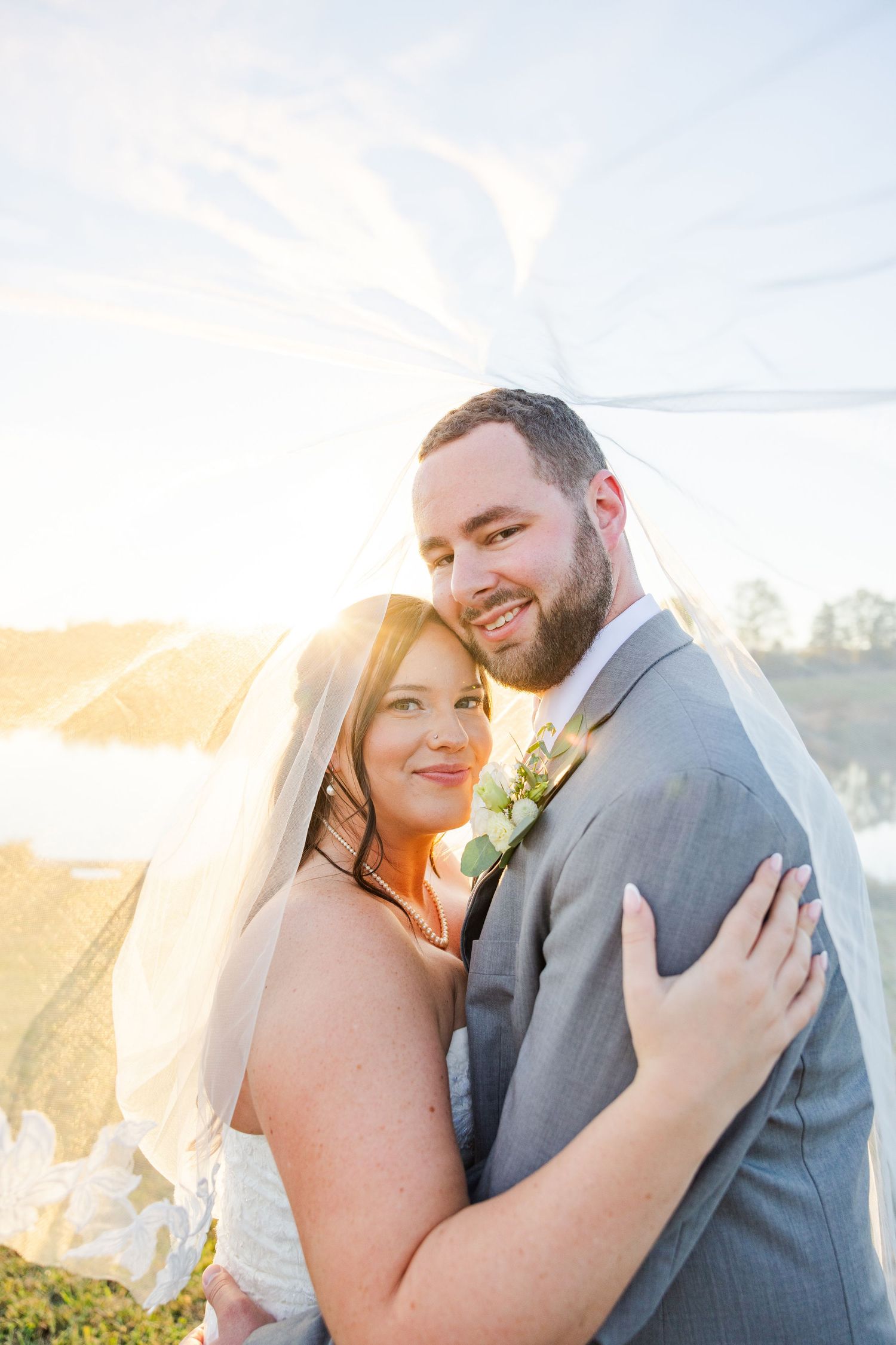 Couple shares intimate moment during golden hour wedding photoshoot.