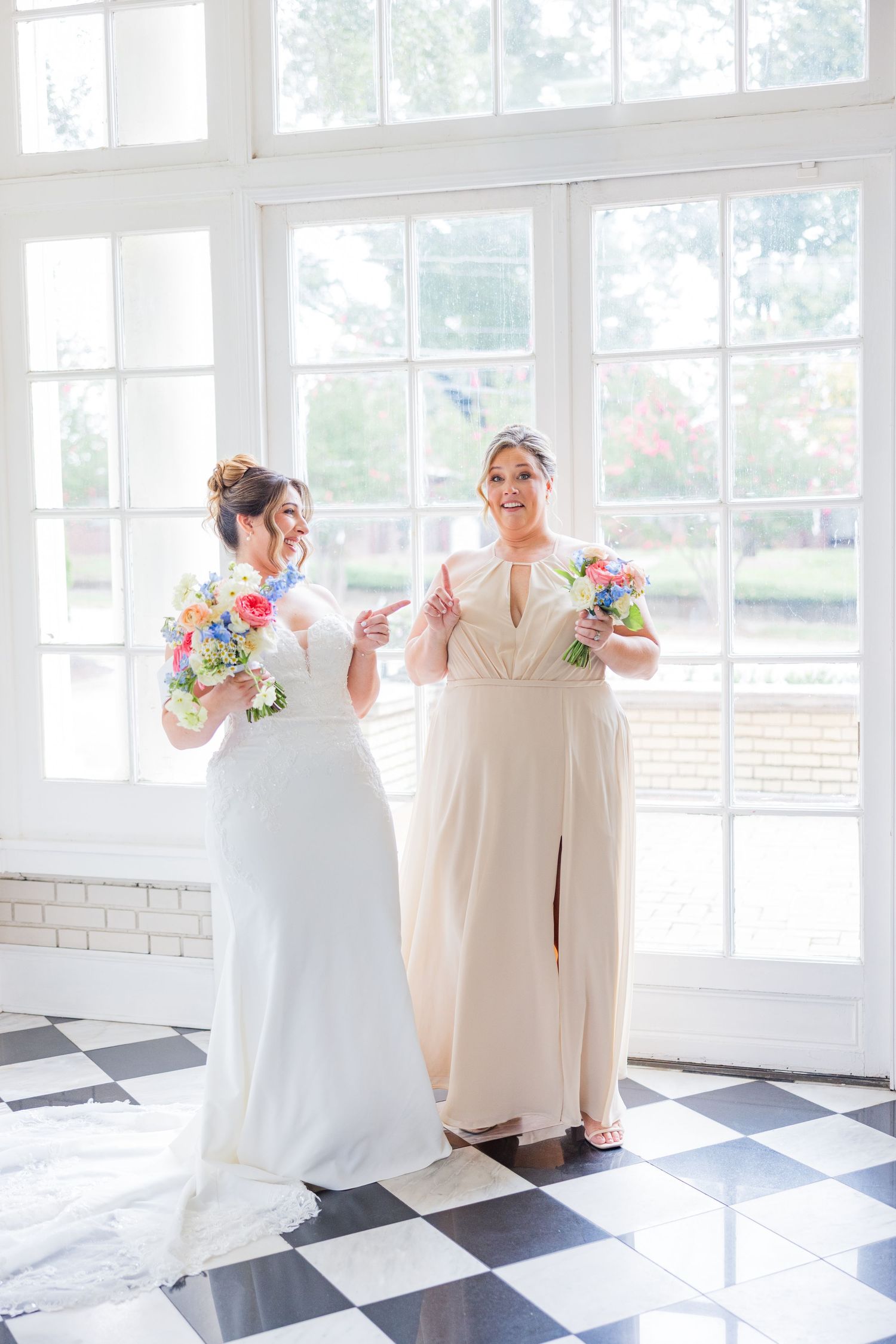 Celebration moments captured in a bright venue with black and white checkered flooring.