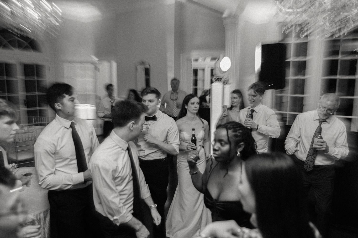 Wedding reception dance floor filled with guests celebrating in a grand ballroom.