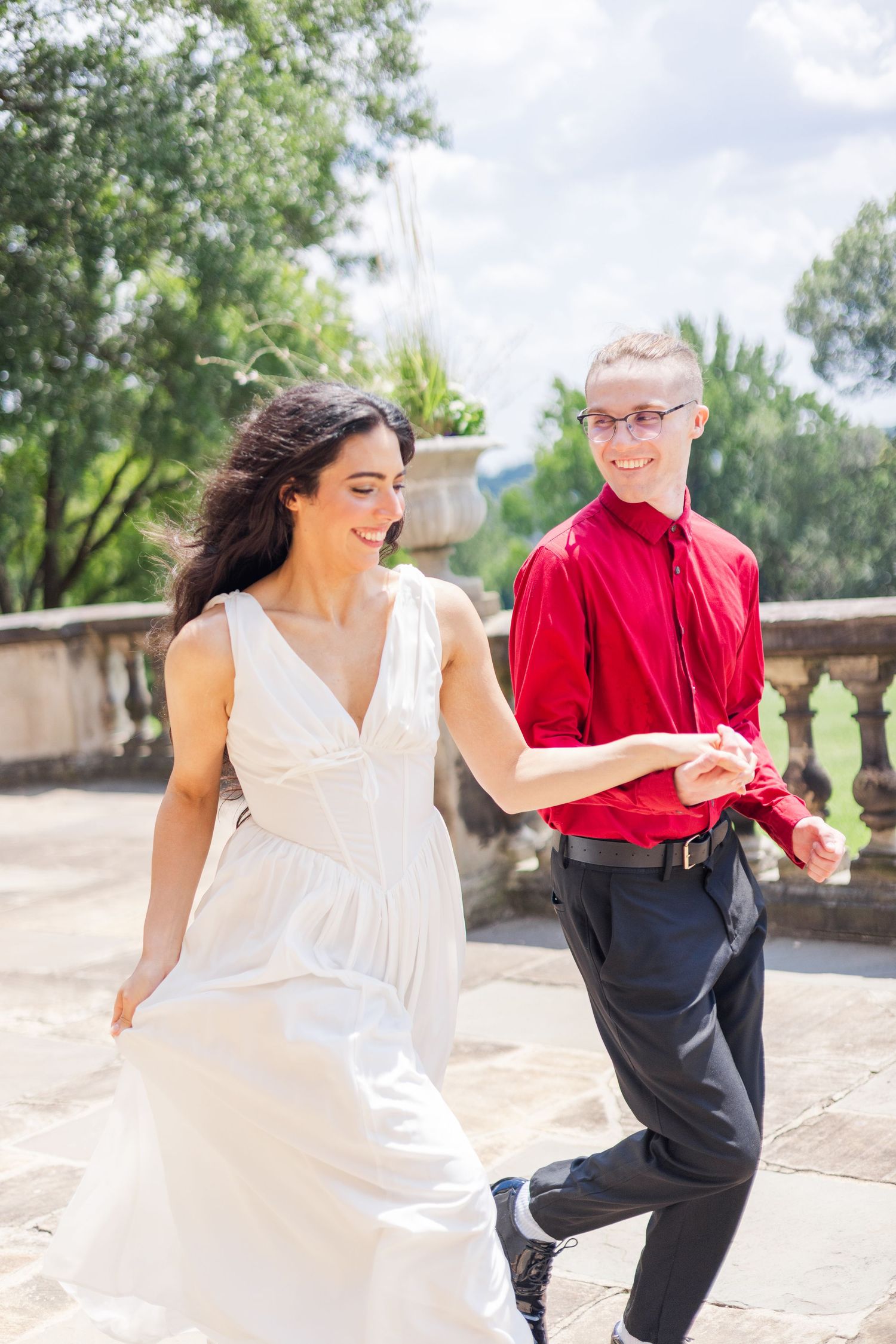 Dancing sequence captured in bright sunlight showing graceful movements against a garden backdrop.