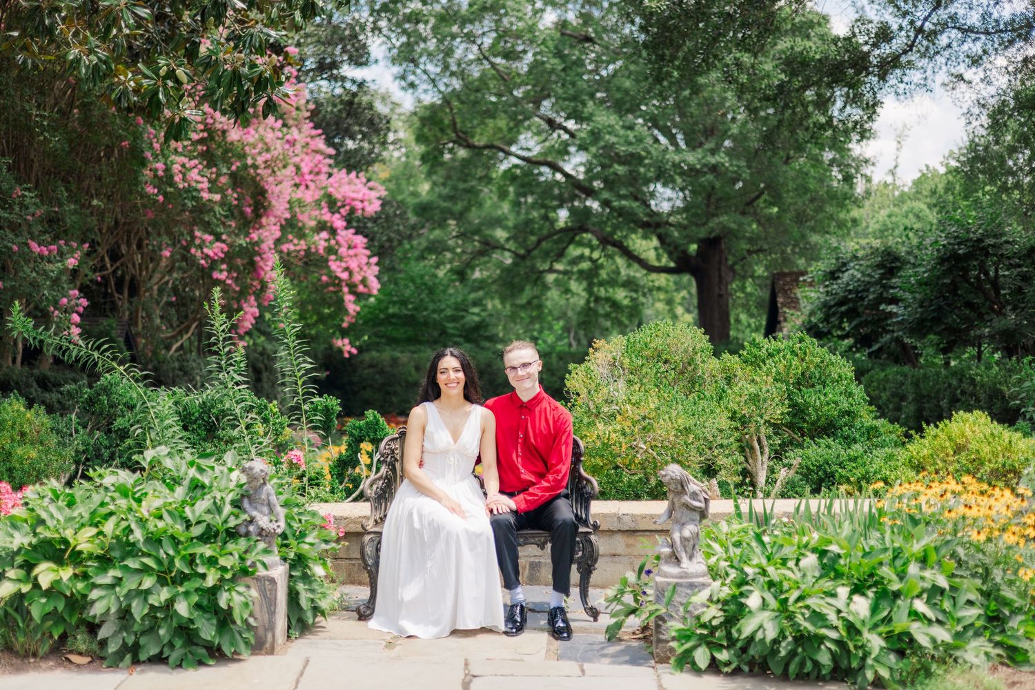 A scenic garden pathway with blooming flowers and lush greenery creates a peaceful outdoor setting.