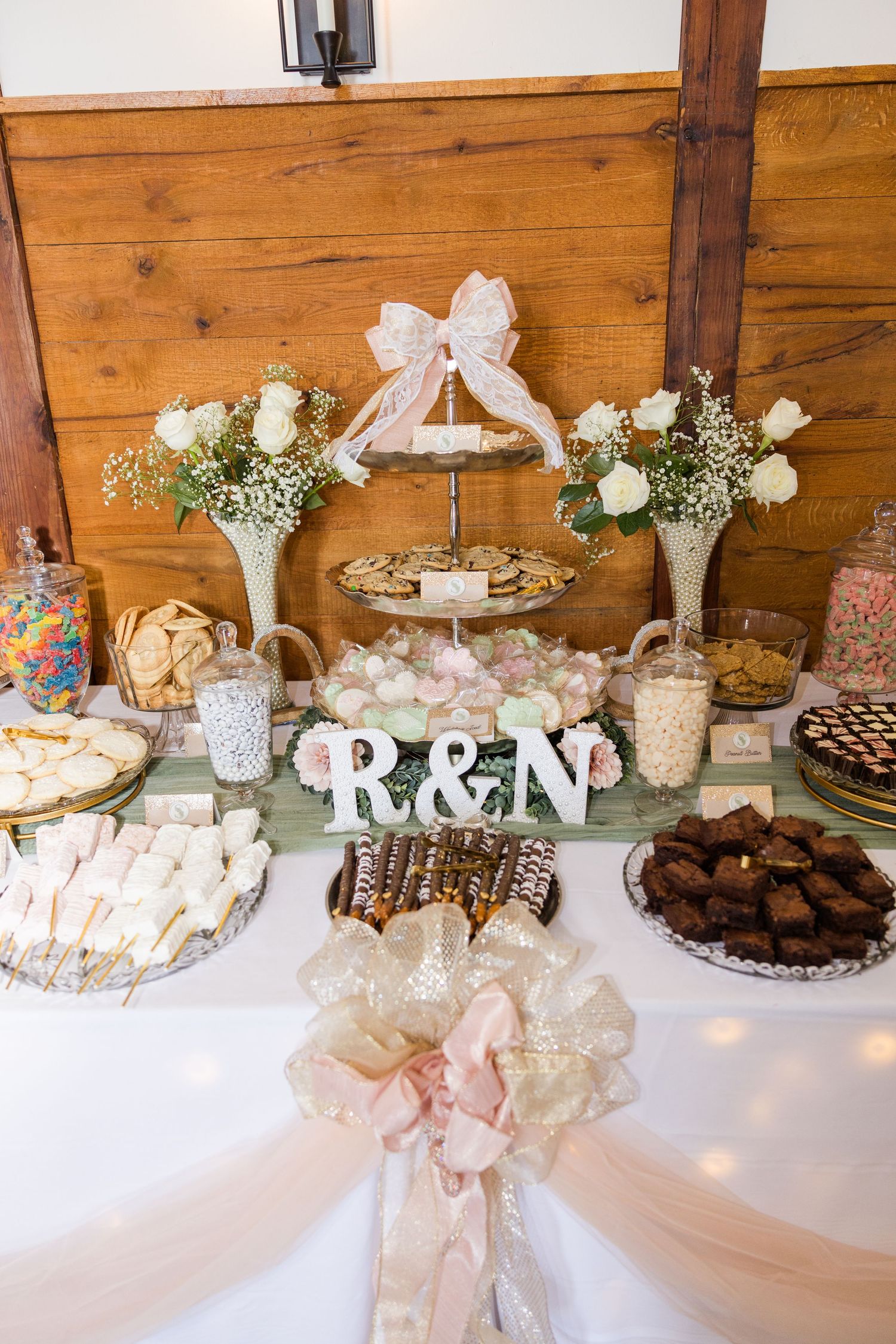Dessert table with sweets and treats decorated in rustic wedding style.