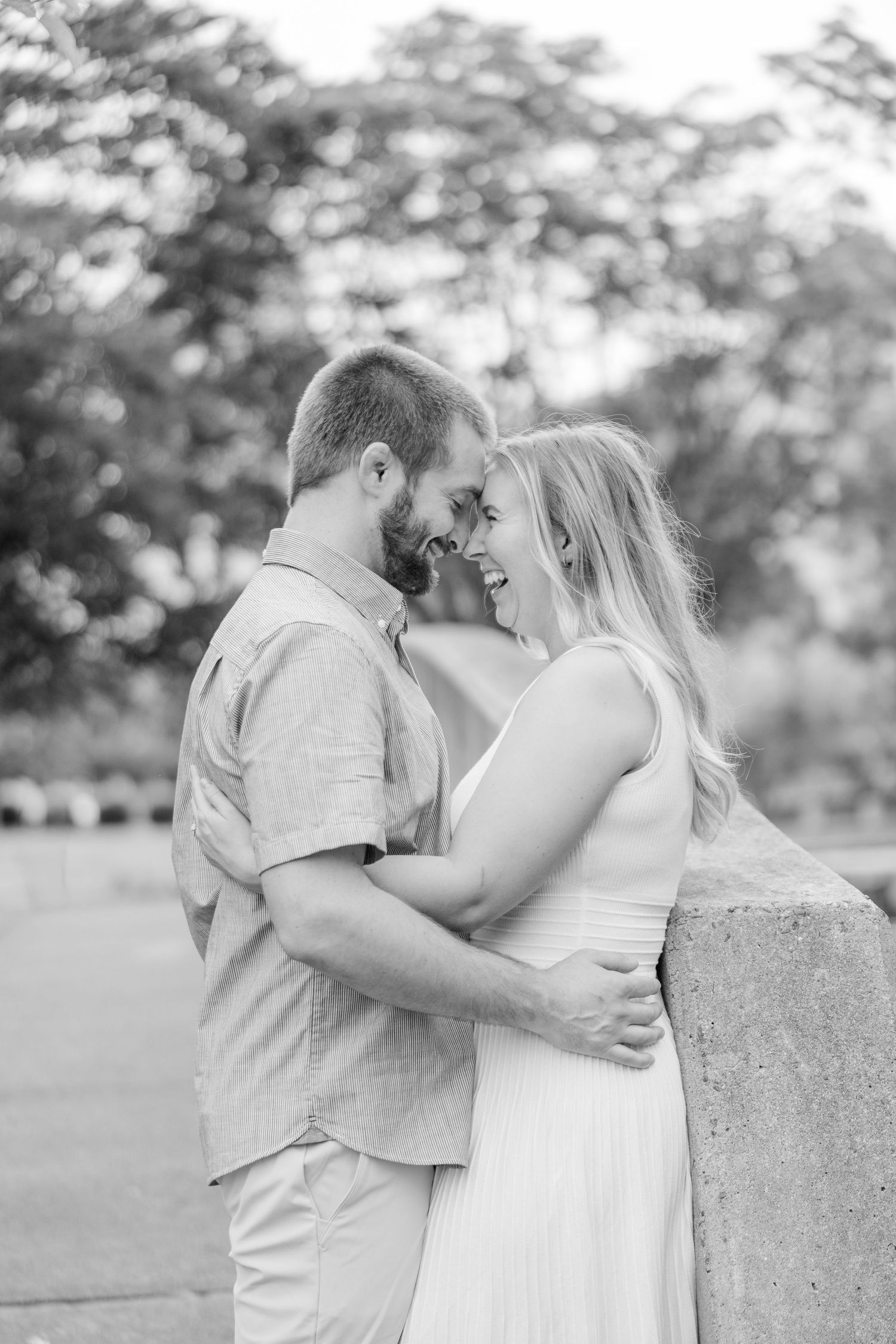 Black and white photos capture tender moments between a couple during an outdoor photoshoot.
