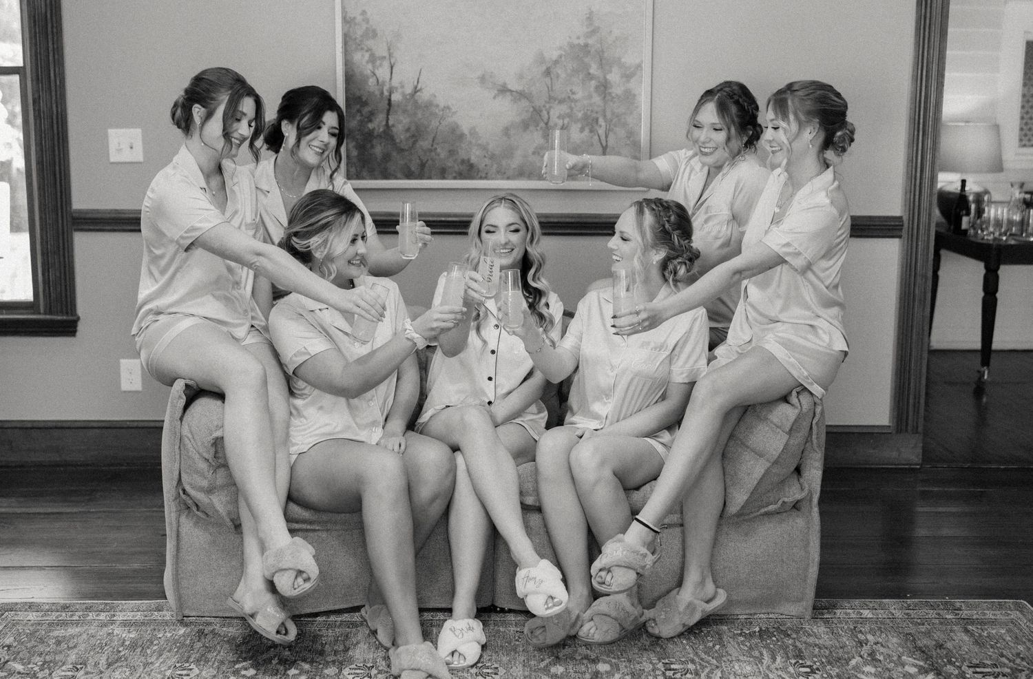 Group of people sitting together on steps in casual attire.