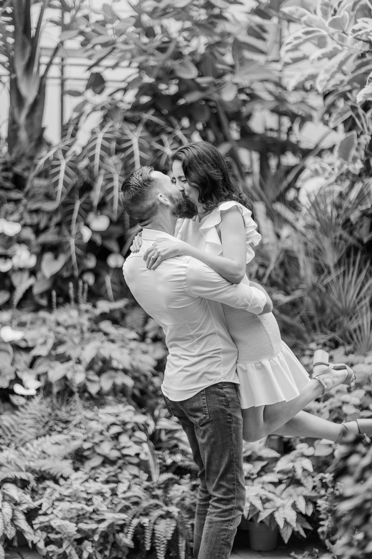 A romantic black and white photo sequence showing an intimate embrace in a garden setting.
